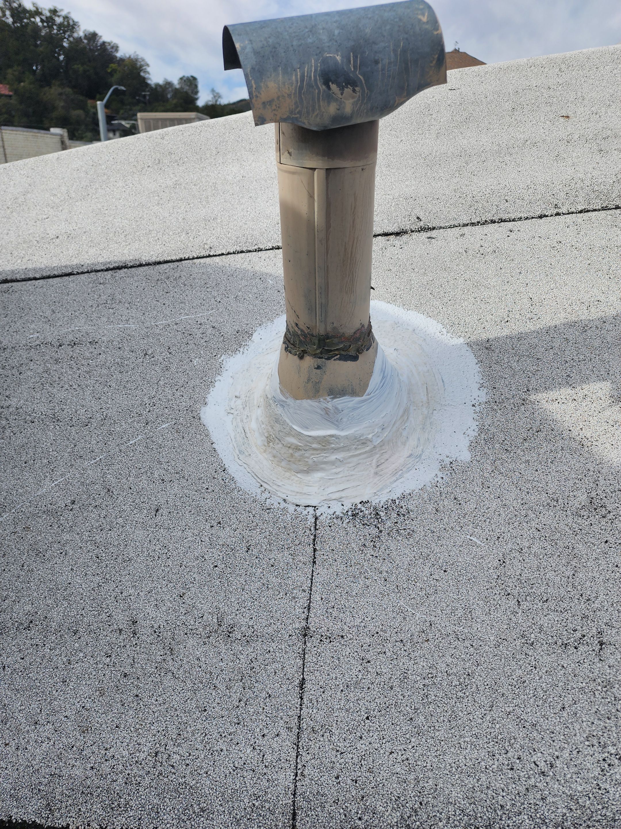 Foam and coatings on commercial roof by Straight Edge Roofing Inc