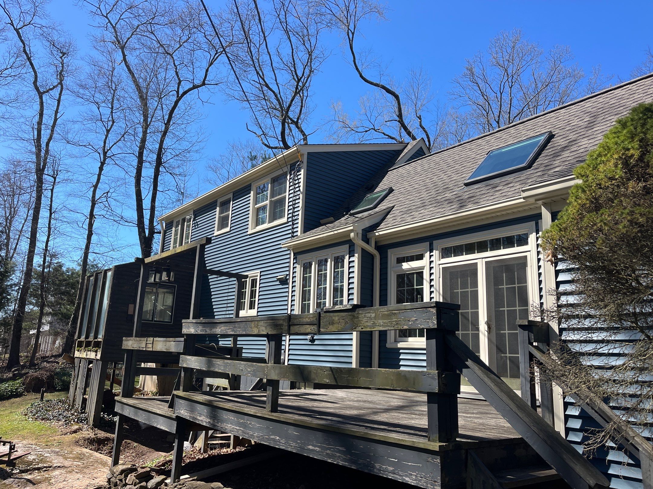 Asphalt shingles meet sleek siding in Guilford. by DiGiorgi Roofing and Siding Inc