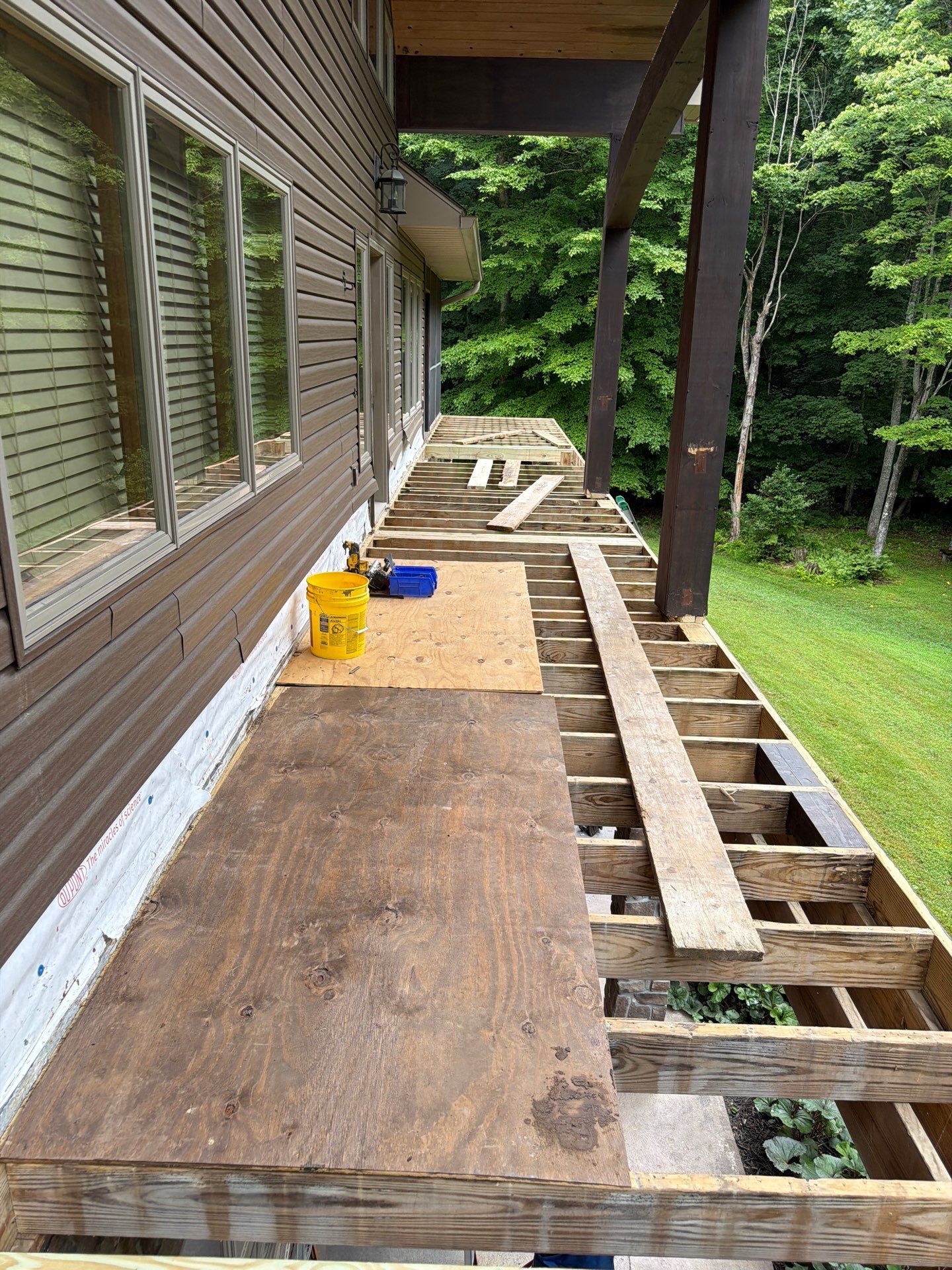 Custom Composite Deck Construction with Stone Pillars in Fayetteville by Walnut Hollow Decks & Outdoor Living