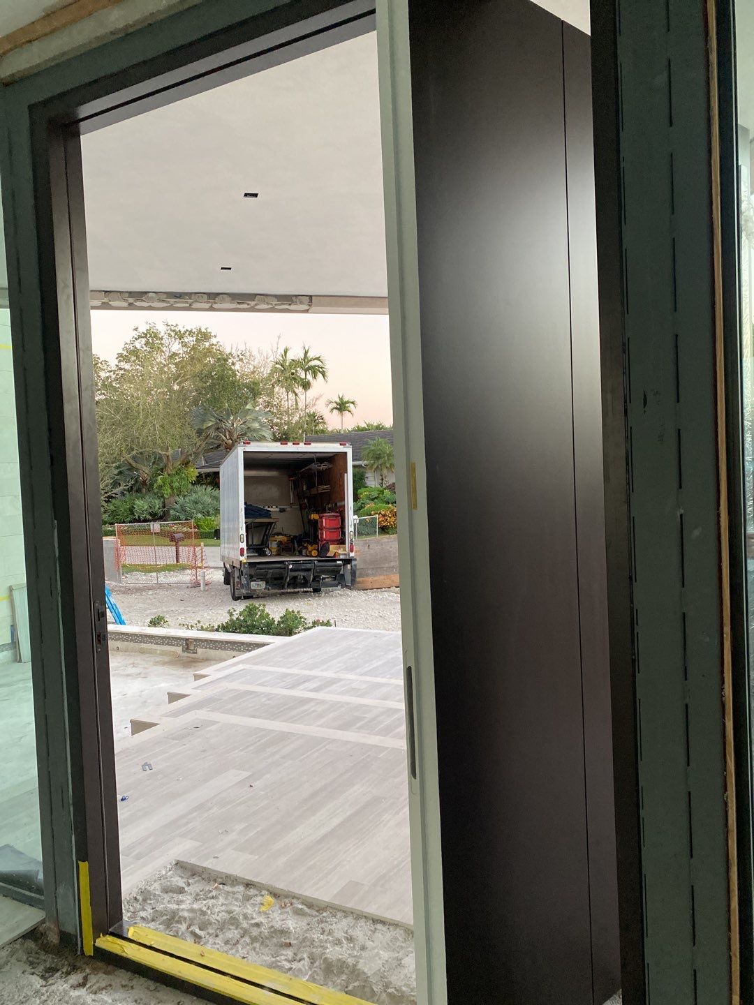 Custom Material Pivot Door installation by Impact Precious Windows and Doors