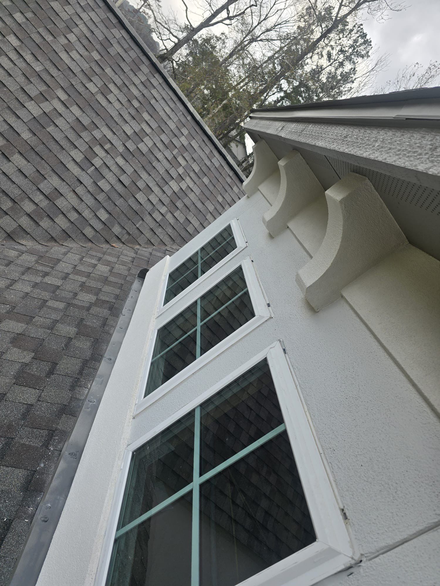 Conroe Elegance: Stucco, Foam Corbels, and Natural Stone Accents. by Apex Conventional Stucco Llc