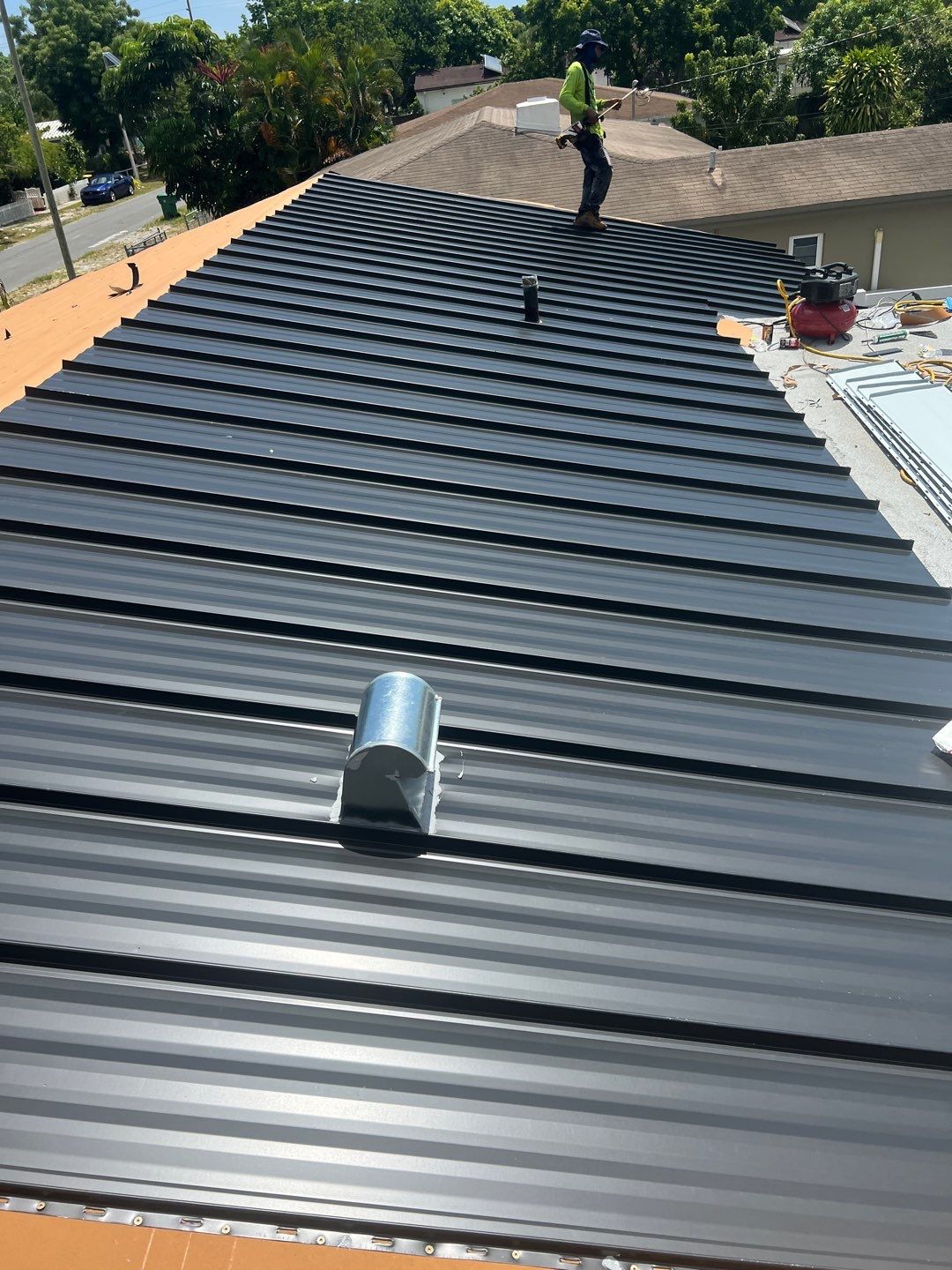 Standing Seam Metal & Flat Re-Roof using 1.5" Nail Strip 24ga Black Matte Kynar Coated Standing Seam Metal Panels by Morton Roofing, Inc.