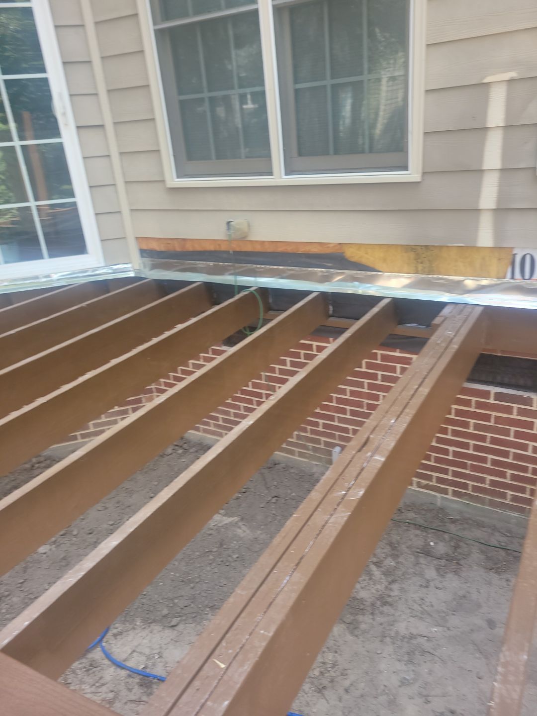 Fuquay-Varina Outdoor Upgrade – Composite Deck & Paved Landing by Elite Remodeling and Design LLC