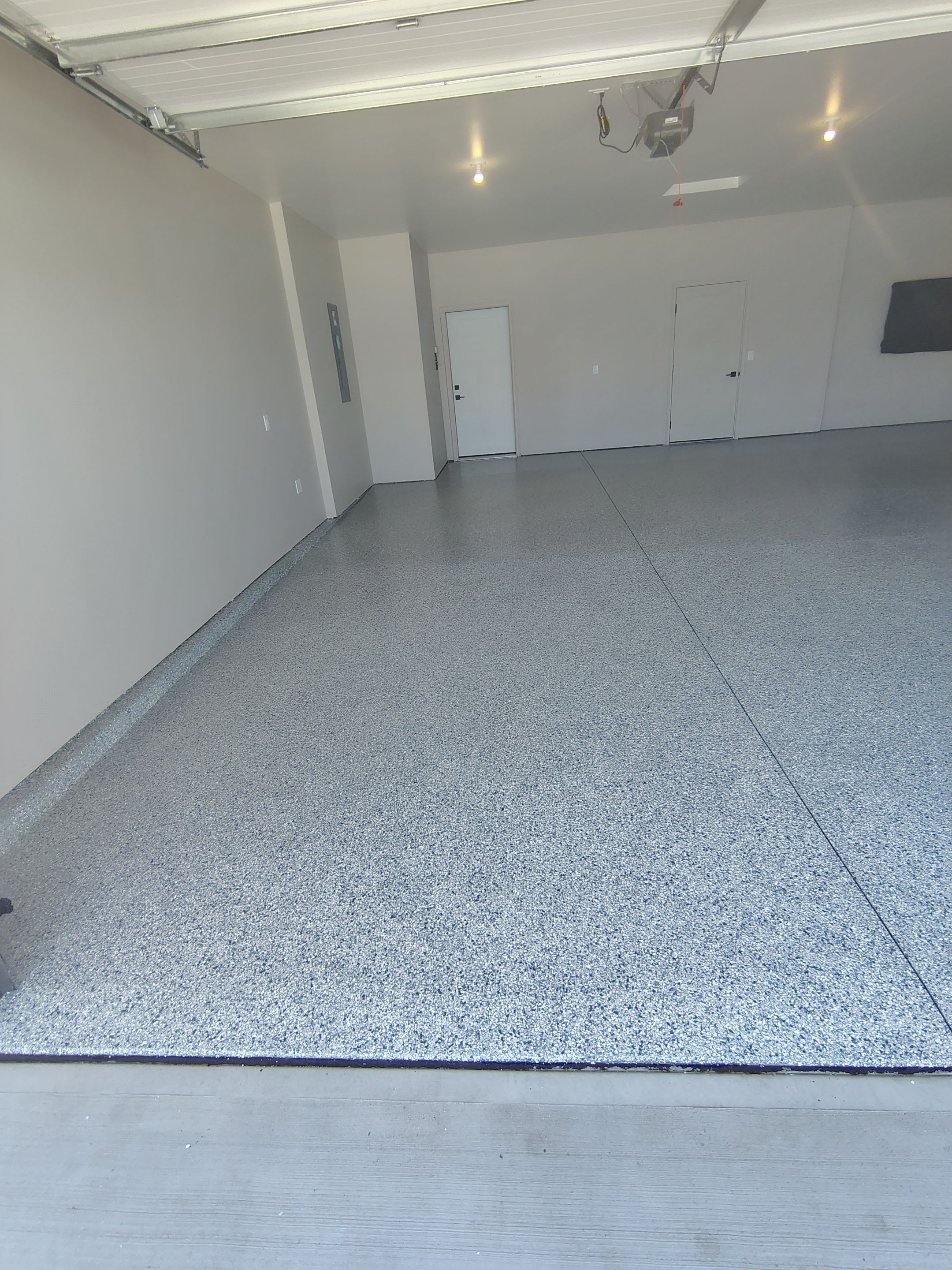 Full Speckled Concrete Coating for Sioux Falls Garage by Select Painting, Coatings & Garage Cabinets