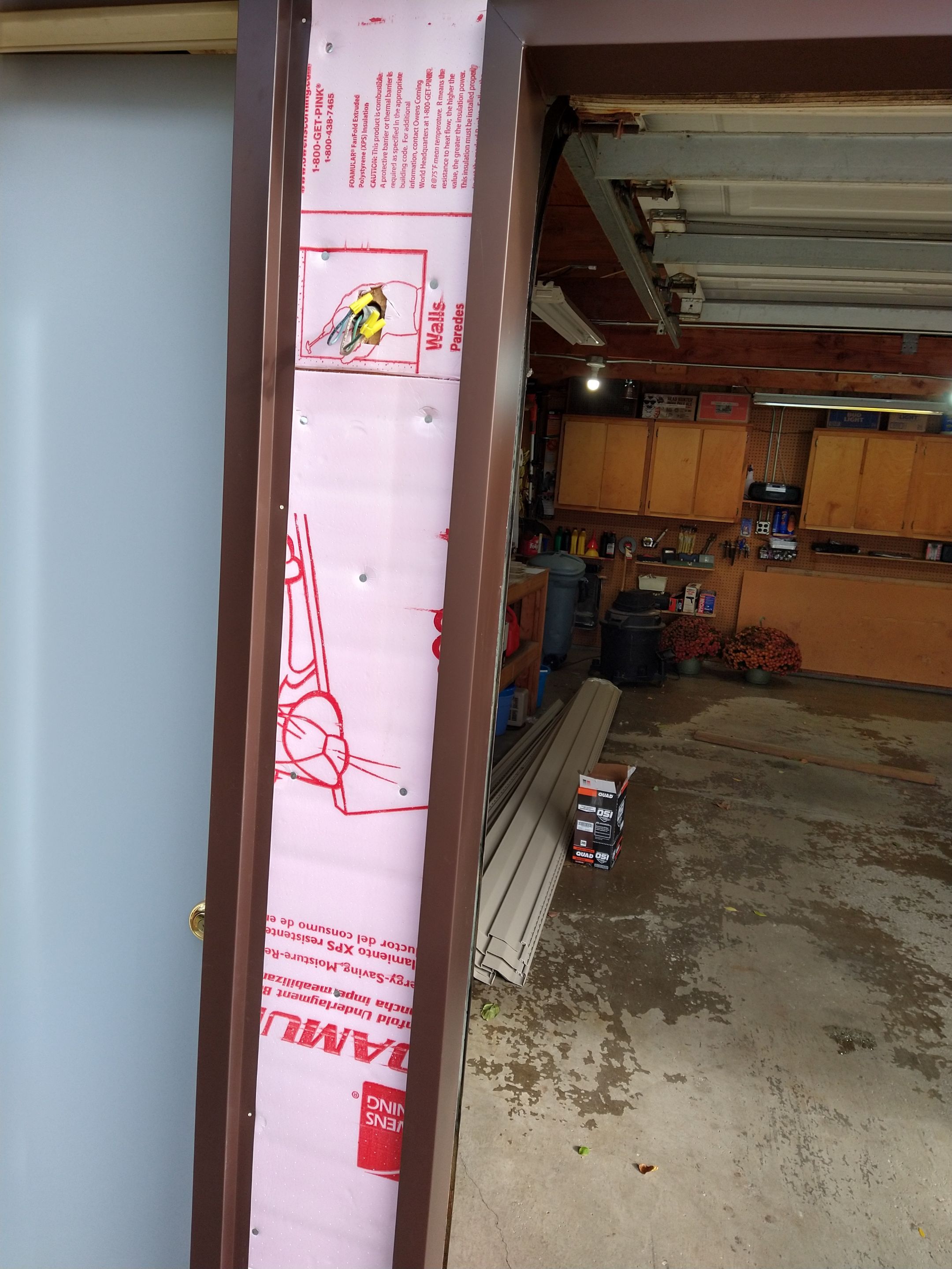 Siding Installation using Norandex woodsman dl-5 white woodgrain vinyl by Absolute Roofing and Construction