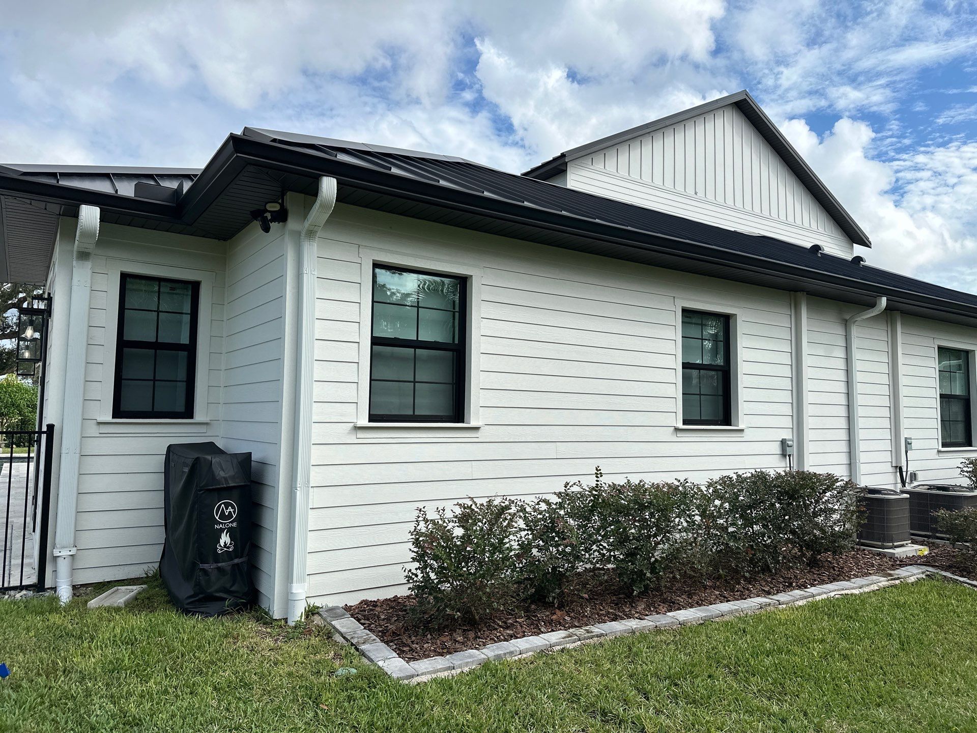 Complete Two-Story House Wash and Driveway Cleaning in Winding River Community, Bradenton, FL by Sunshine AquaWash