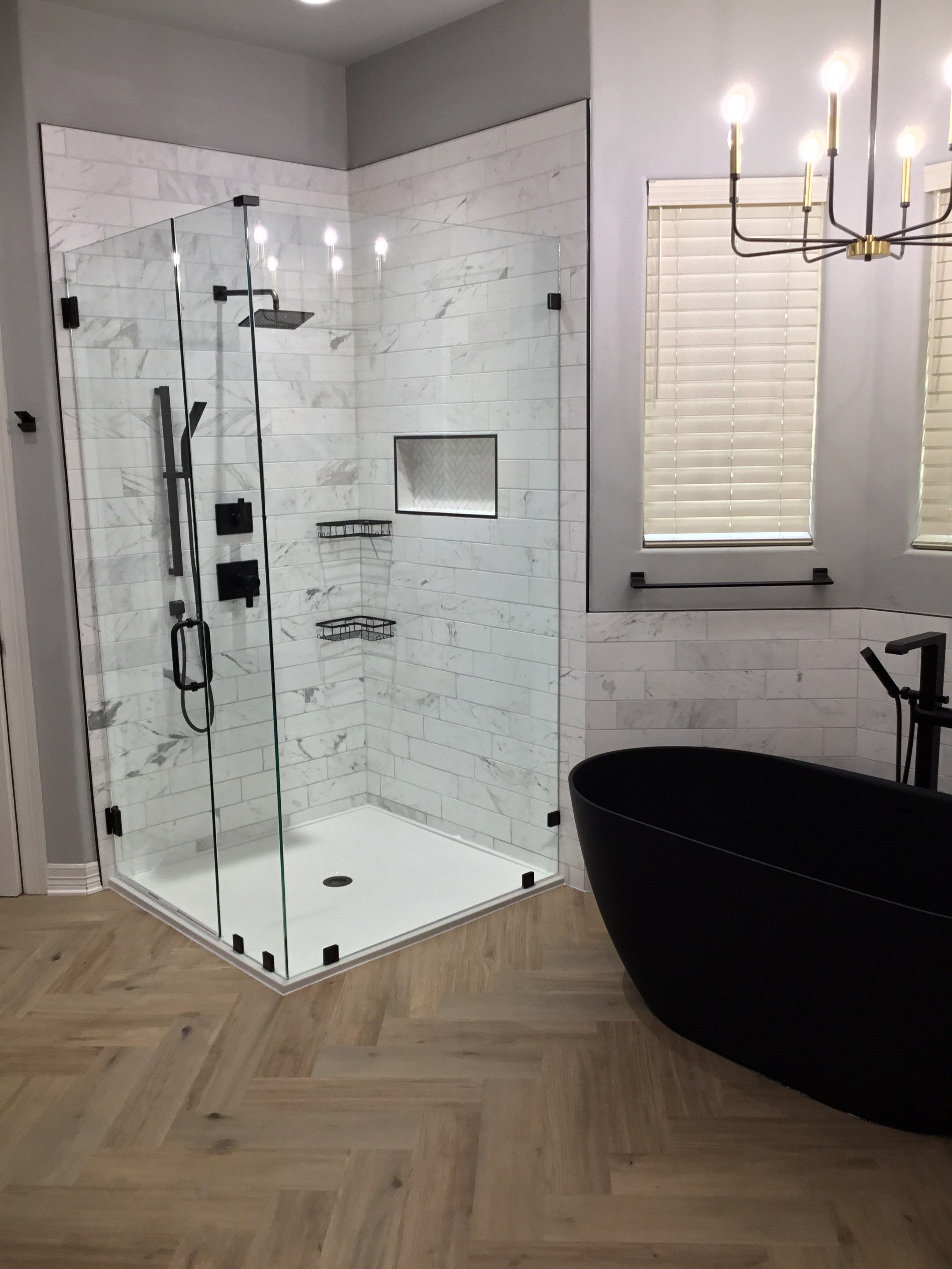 Spring Bathroom Remodel with Black Free-Standing Tub and Walk-In Shower by Legacy Bath and Kitchen