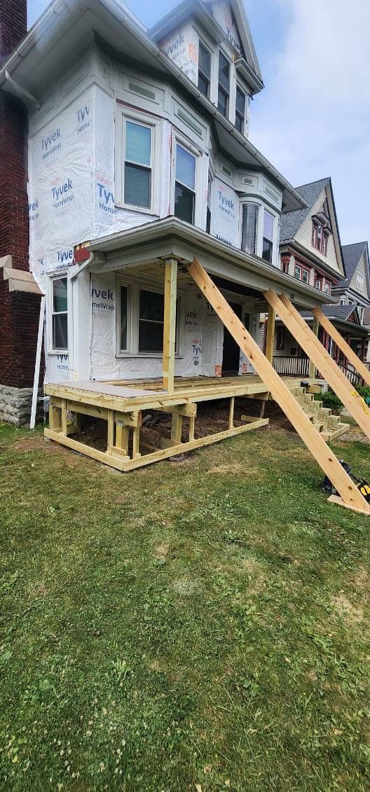 Exterior Renovations- Siding, Stamped Concrete, Porch, and Railings by Ivy Lea Construction