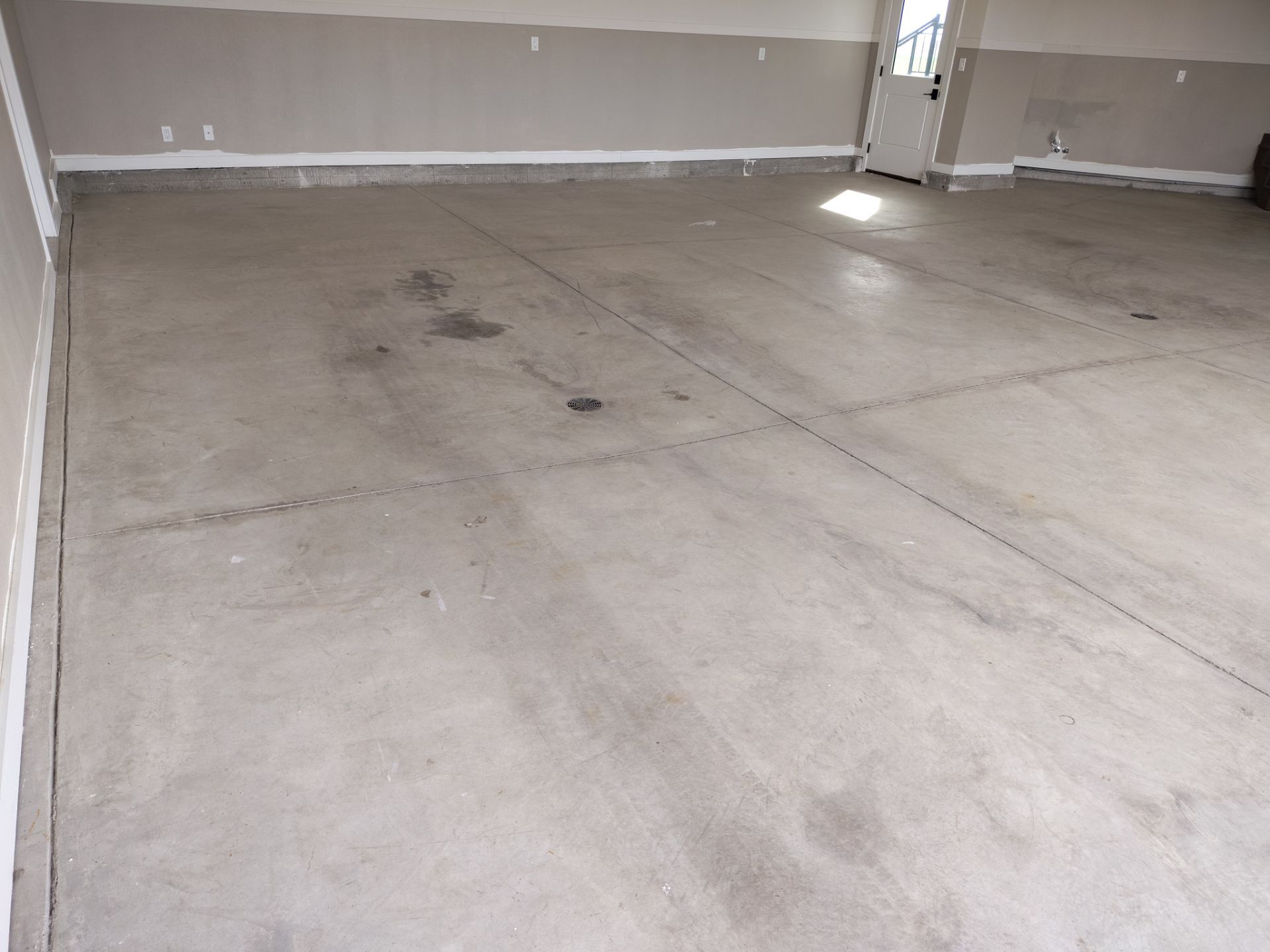 Ames Garage Floor Transformation with Gray and White Speckled Epoxy by Revival Concrete Coatings