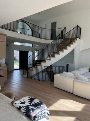 Curved Oak Staircase and Custom Metal Railing Installation in Lone Tree