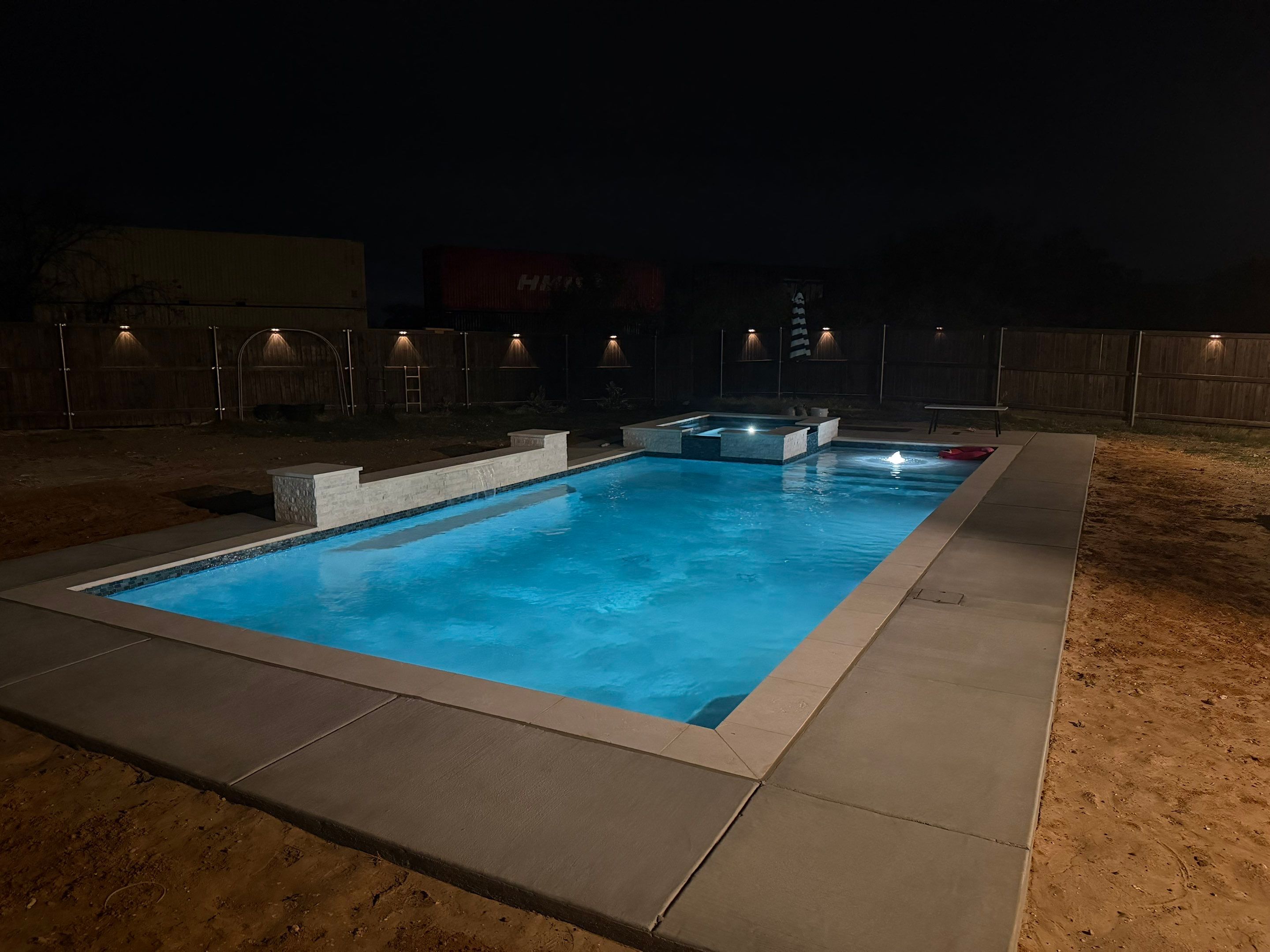 Geometric Pool with Elevated Spa and Night Lighting by Pinnacle Pools and Spas - DFW