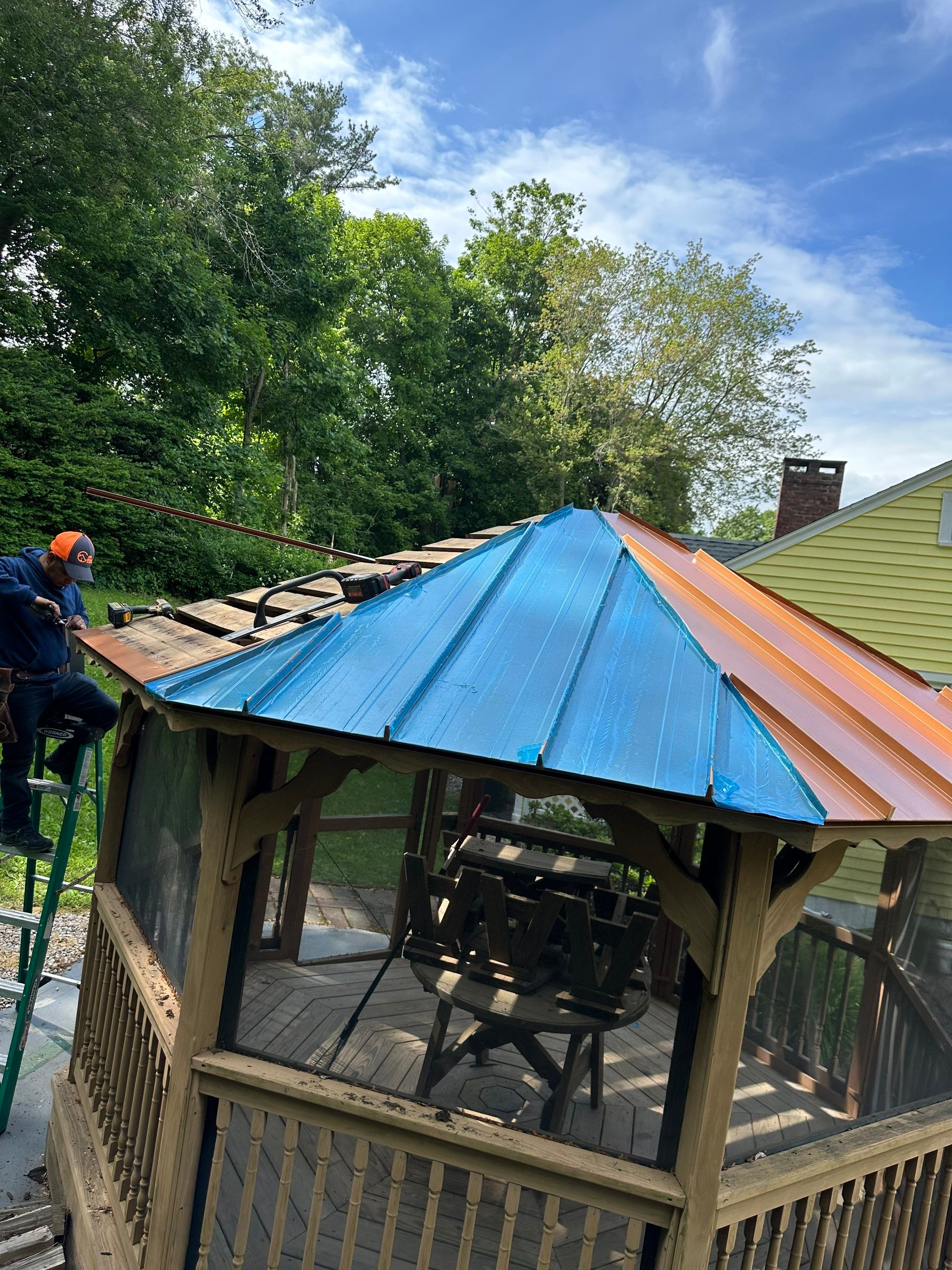 Residential Roofing Installation using Copper Penny Metal Roof by A Plus Exterior
