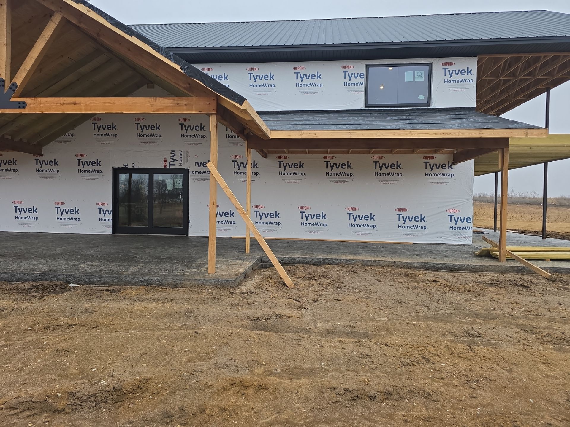 New Home construction w/ board and batten sides and metal roof  by Miles Construction 