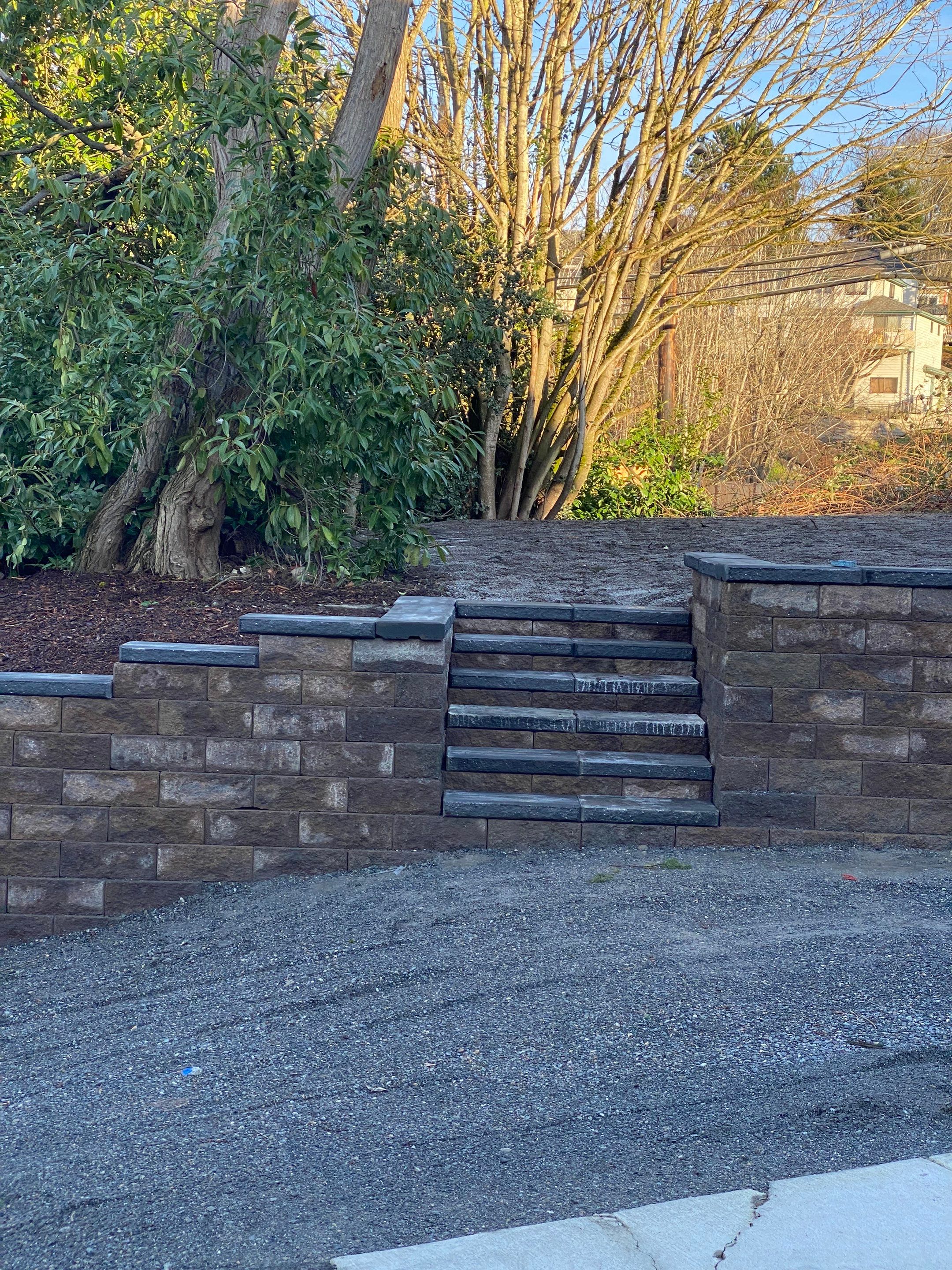Patio Installation using Concrete, Retaining walls, and Turf install by Jireh Asphalt & Concrete Inc 