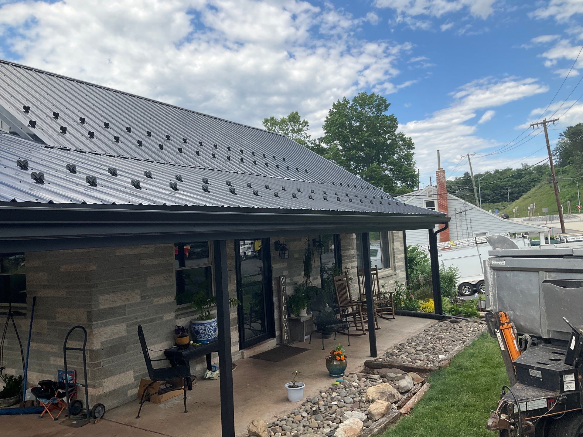 Metal Roofing, Board & Batten Siding, and Entry Door Transformation by Esh Builders