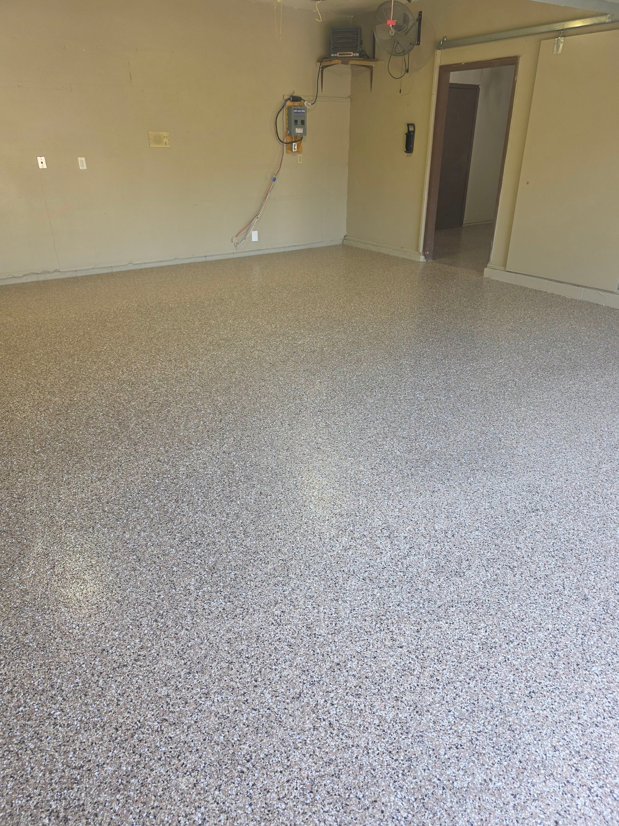 Residential Garage Epoxy Floor Coating Installation in Sioux Falls by Select Painting, Coatings & Garage Cabinets