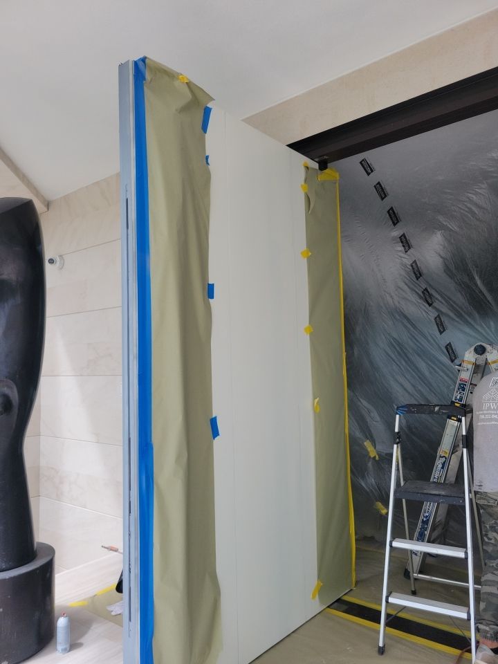 Custom Material Pivot Door installation by Impact Precious Wood Inc.