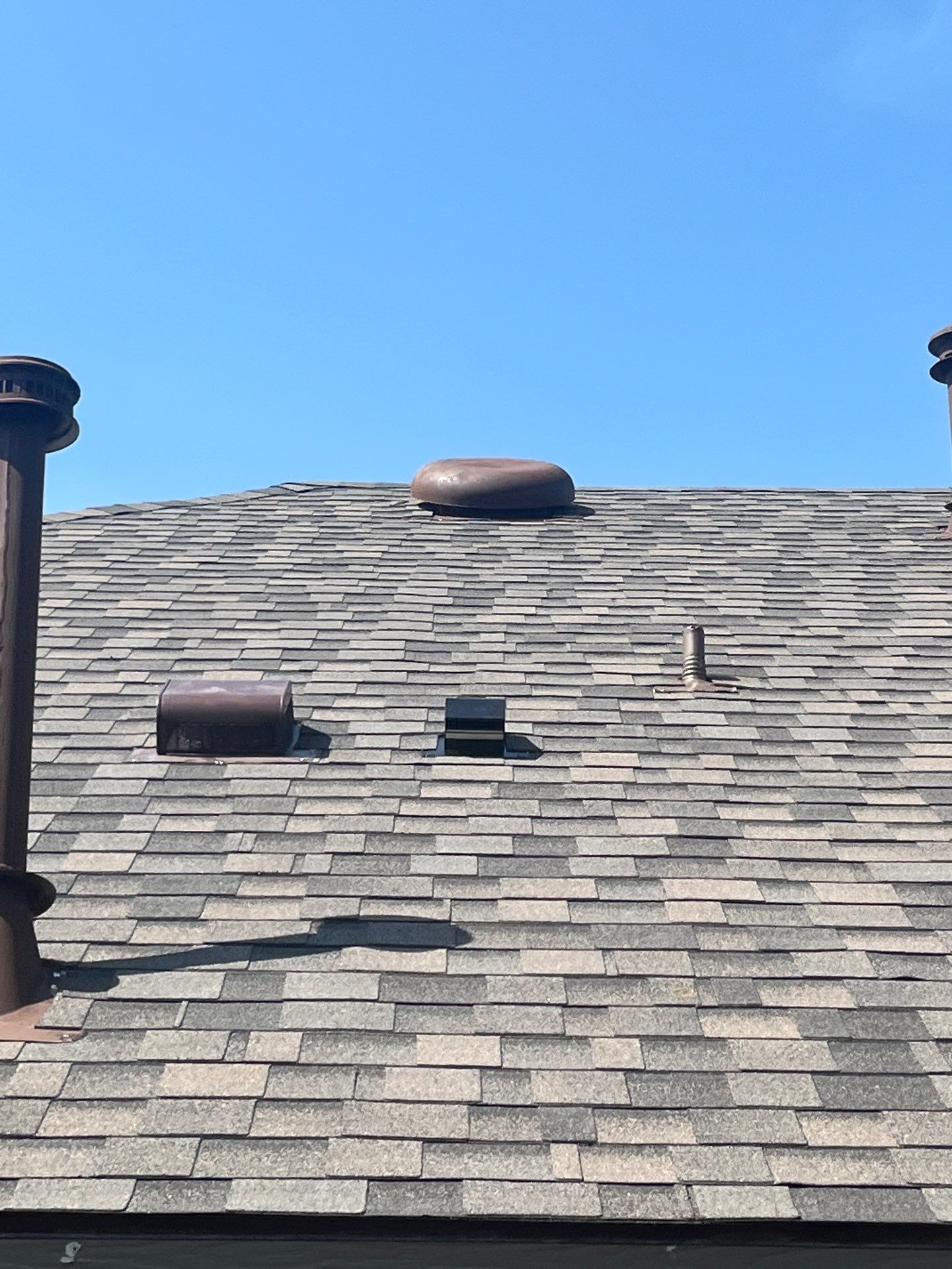 Medium brown brick with IKO Driftshake by Tejas Roofworks + Restoration