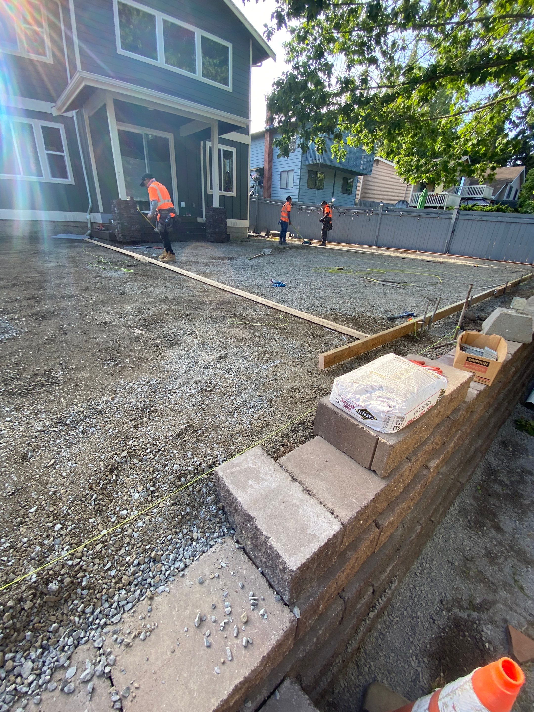 Patio Installation using Concrete, Retaining walls, and Turf install by Jireh Asphalt & Concrete Inc 