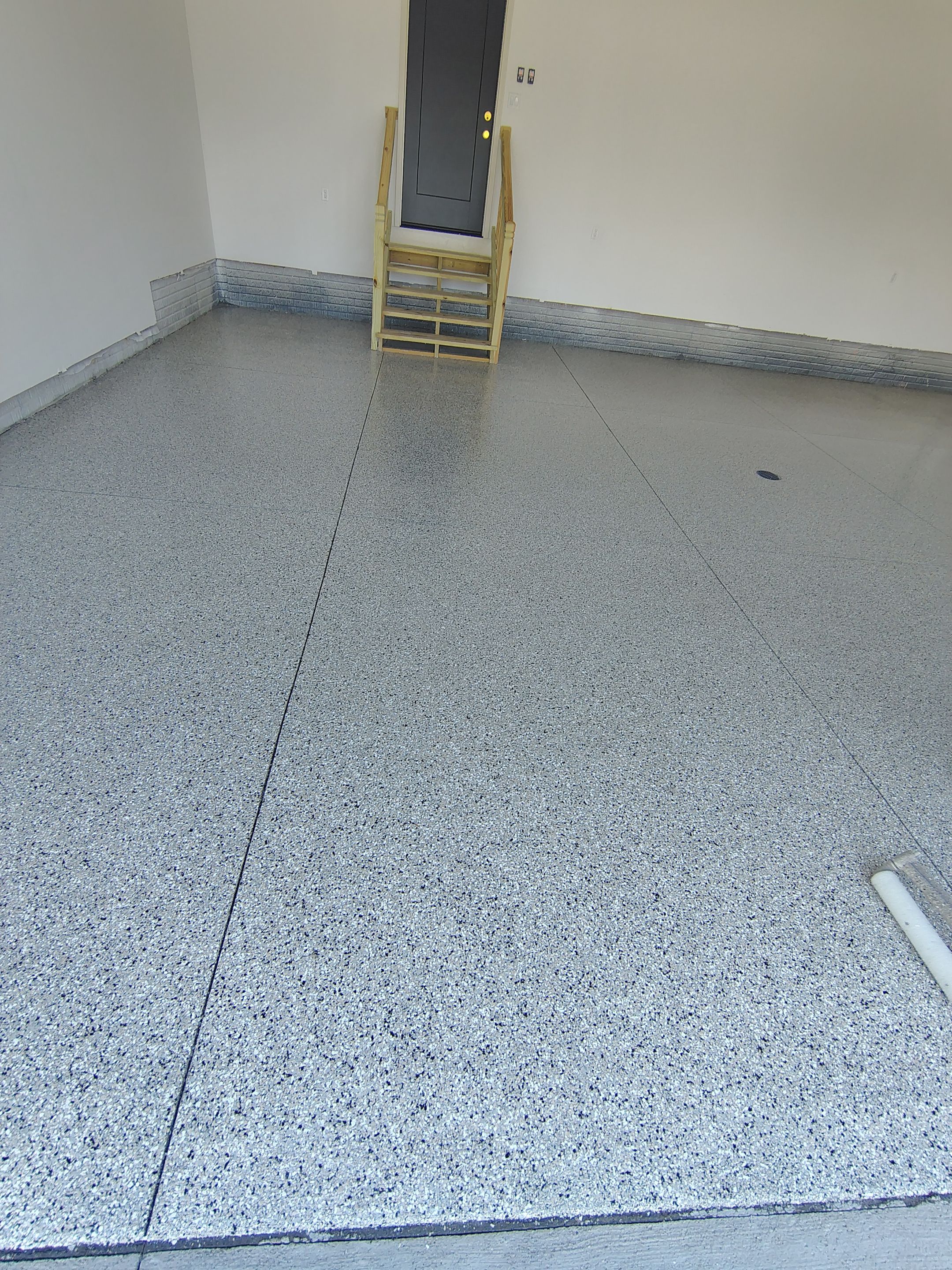Cabin Fever Decorative Flake Garage Floor Coating in Sioux Falls by Select Painting, Coatings & Garage Cabinets