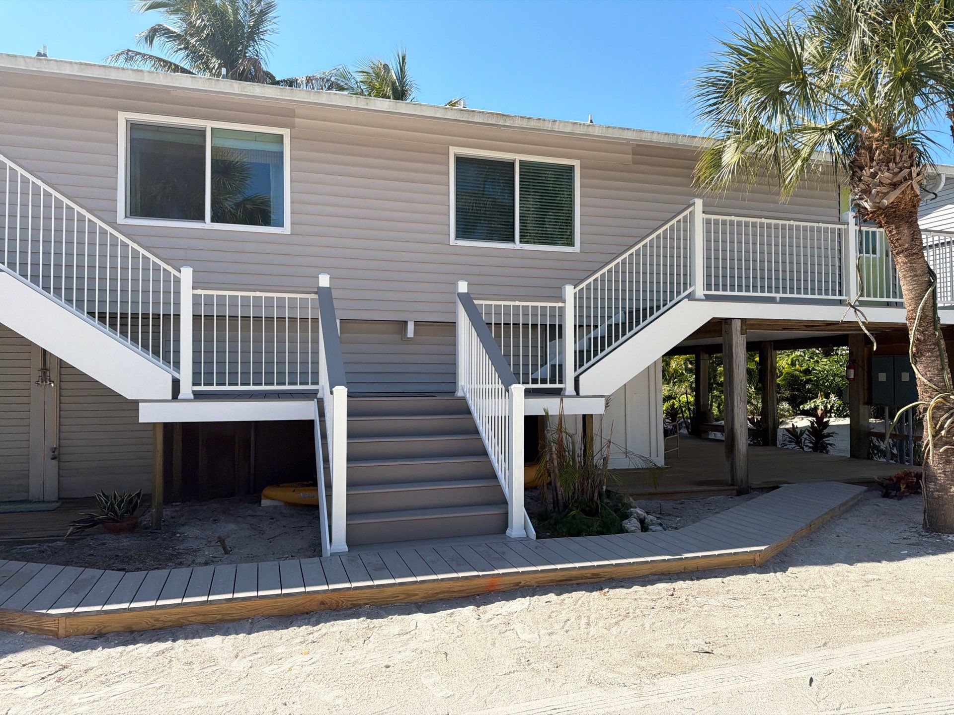 Elevated Coastal Home Renovation with Siding and Custom Decks in Englewood by Smirnov Construction Inc