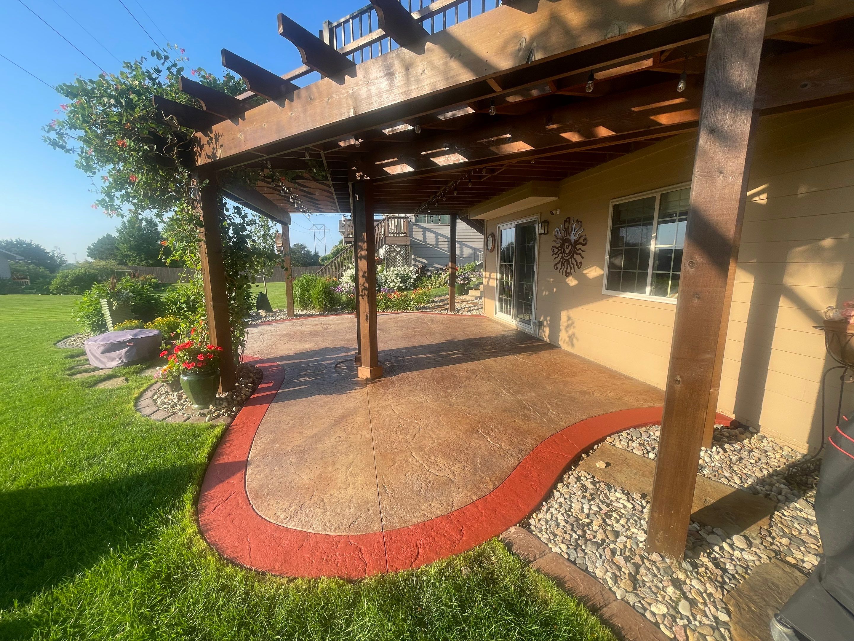 Custom Stamped Concrete Patio and Wood Pergola in Sioux Falls by Select Painting, Coatings & Garage Cabinets