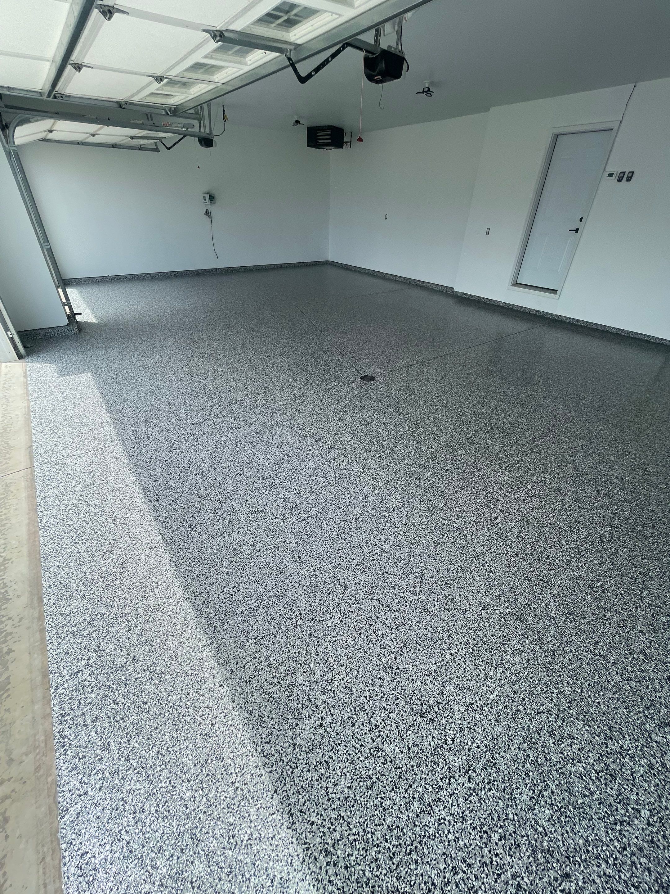 Grey Flake Epoxy Garage Floor Coating in Sioux Falls by Select Painting, Coatings & Garage Cabinets