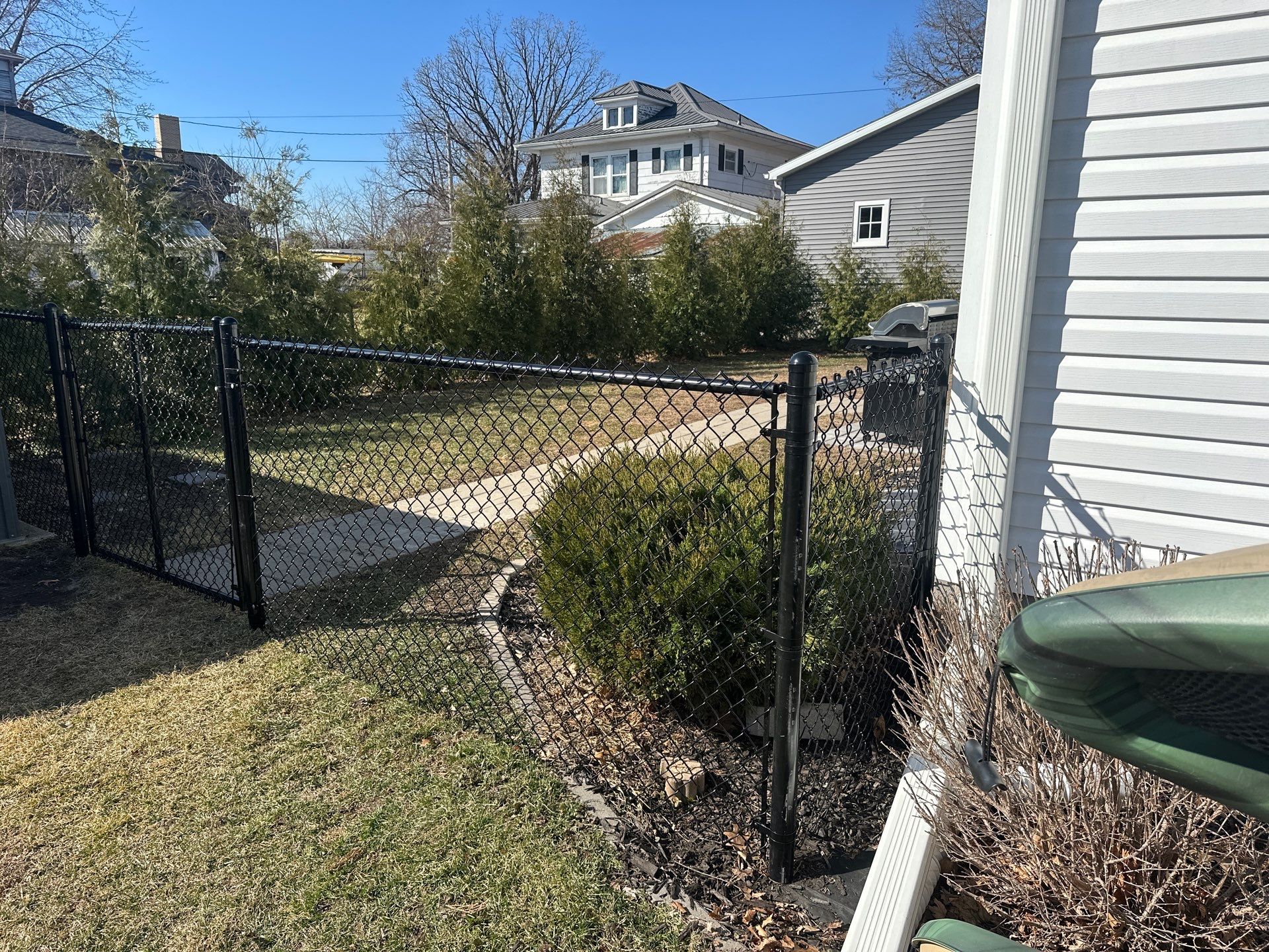 Black Chain Link Backyard Fence Installation in Independence by Perfect Picket Fence and Stain