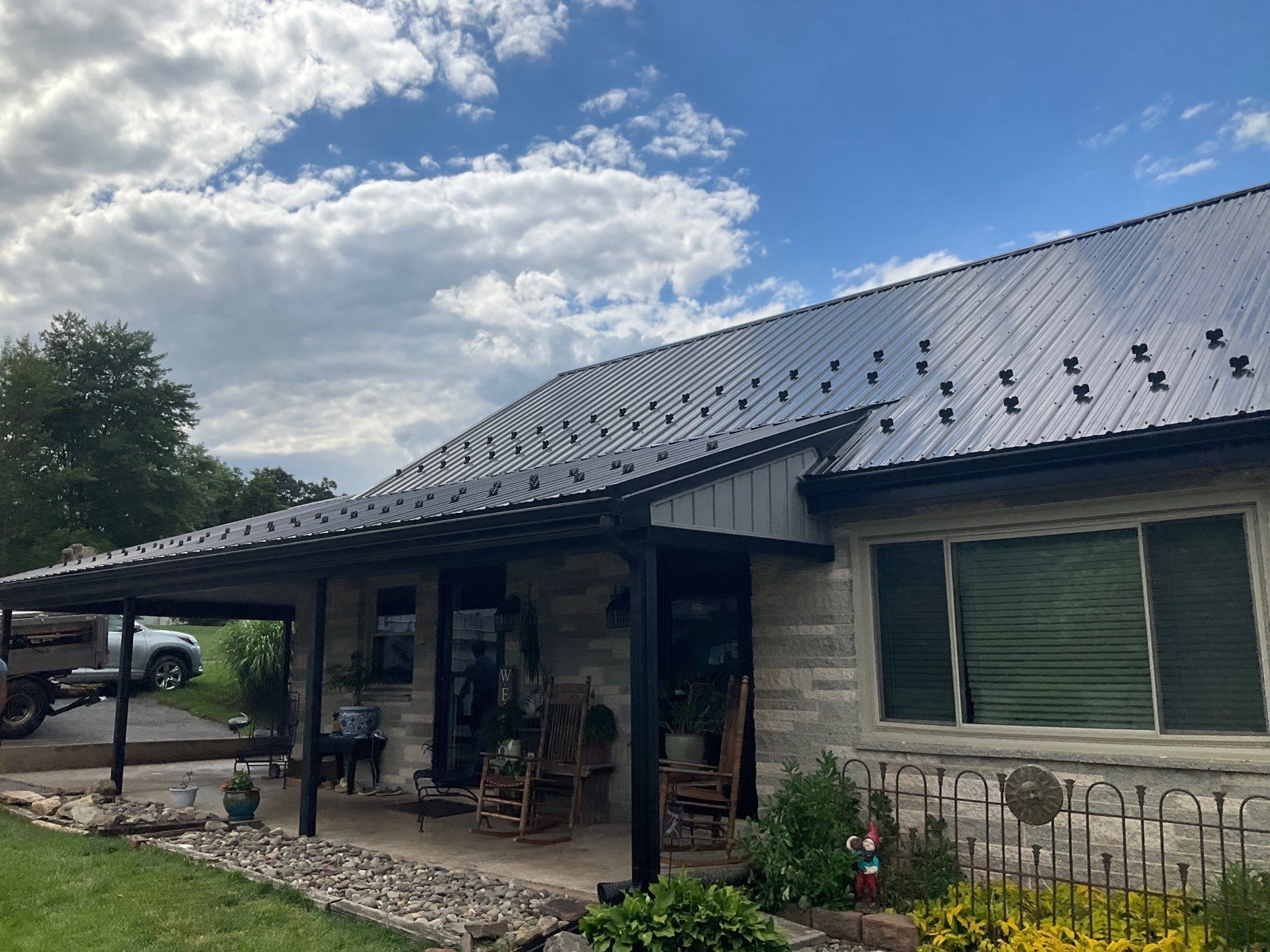 Metal Roofing, Board & Batten Siding, and Entry Door Transformation by Esh Builders