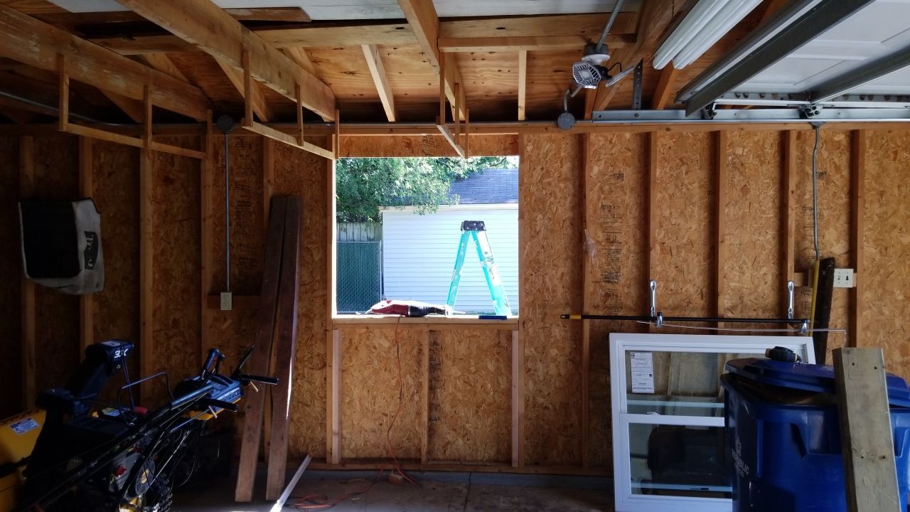 Siding Installation using Norandex woodsman dl-5 white woodgrain vinyl by Absolute Roofing and Construction