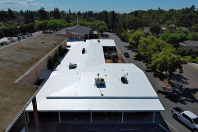 Single-ply restoration system using Benchmark/PUMA XL coatings over TPO single-ply roofing