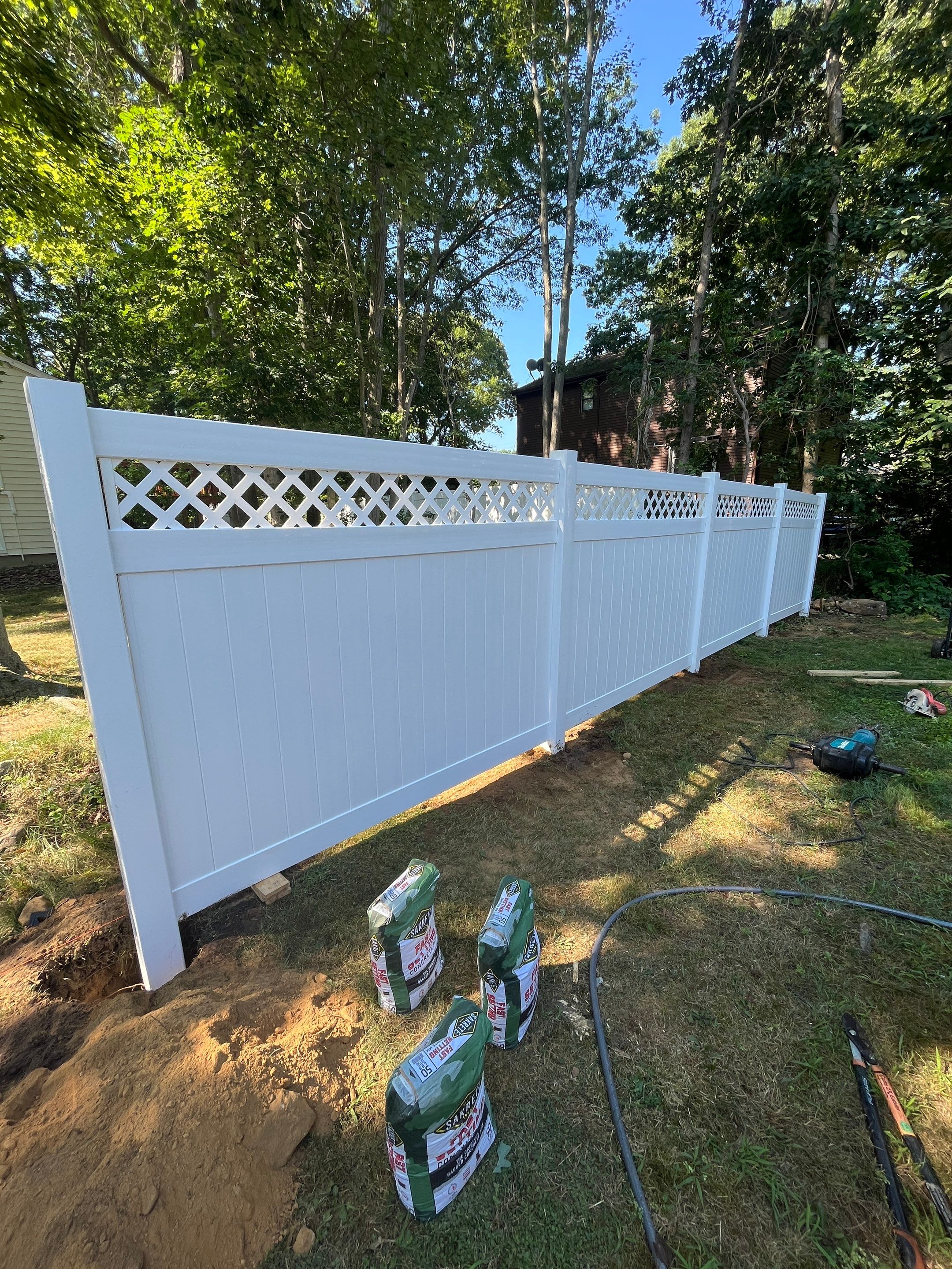 Vinyl privacy fence with Lattice top, White  by DiGiorgi Roofing and Siding Inc