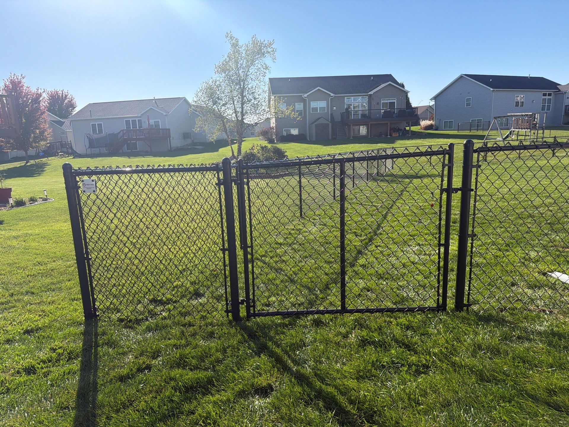 Black Vinyl-Coated Chain Link Fence Installation in Cedar Falls by Perfect Picket Fence and Stain