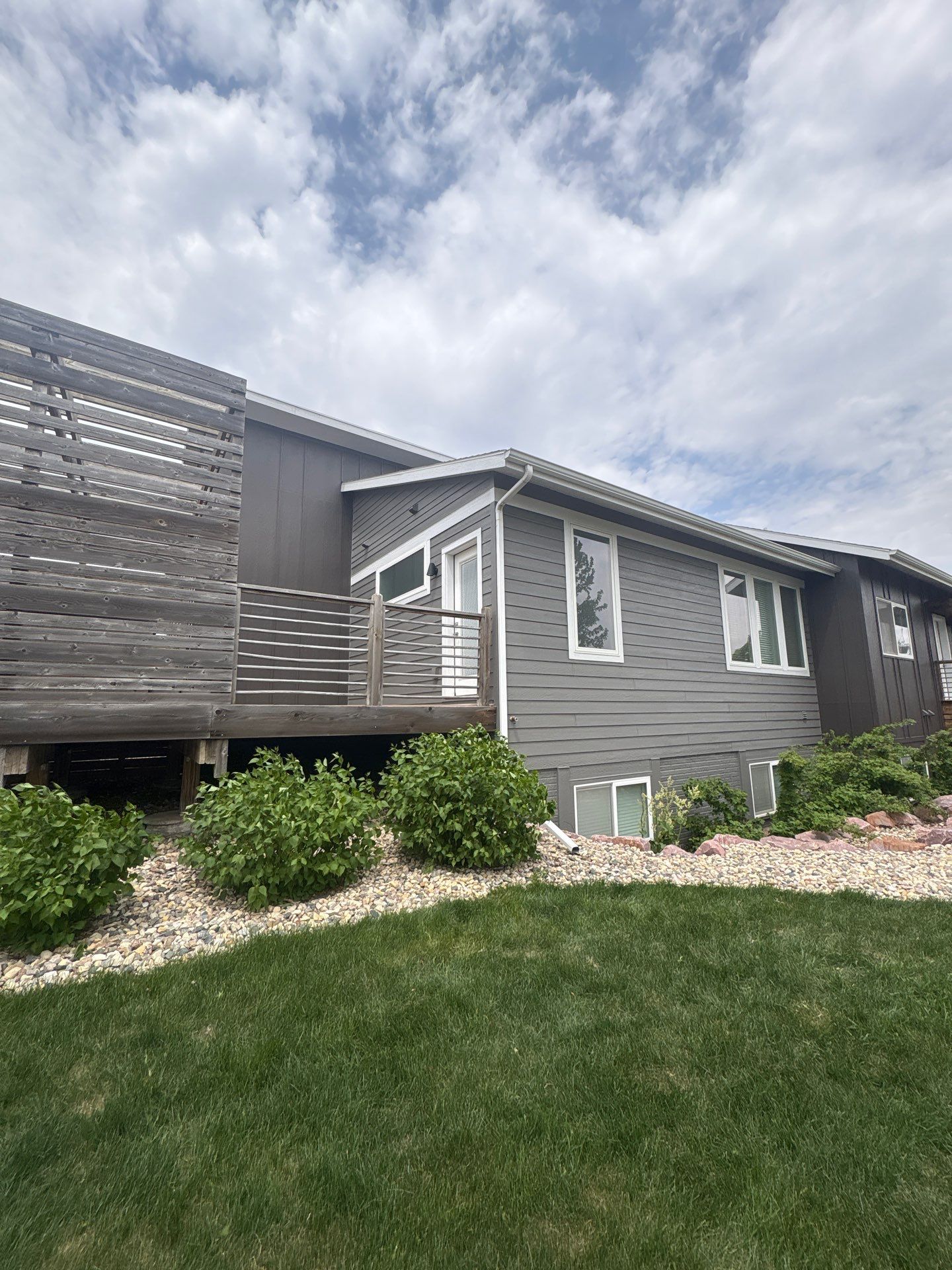 Modern Exterior Transformation Featuring Dark Board and Batten Siding in Sioux Falls by Select Painting, Coatings & Garage Cabinets