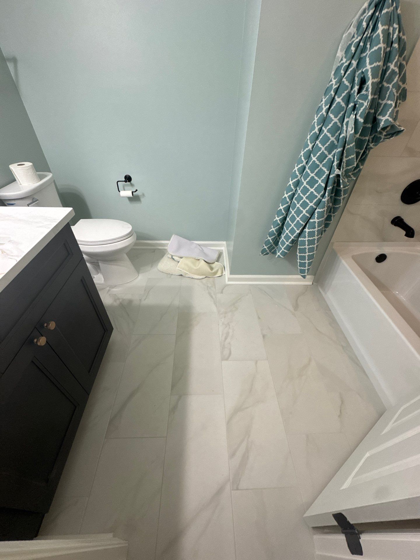 Modern Bathroom Transformation With Marble Patterned Tile in Powder Springs by Swift Home Renovations