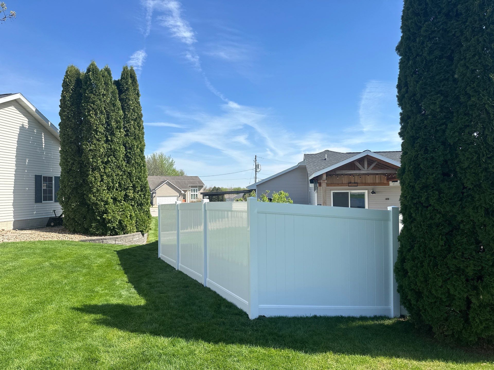 White Vinyl Privacy Fence Installation in Raymond, Iowa by Perfect Picket Fence and Stain