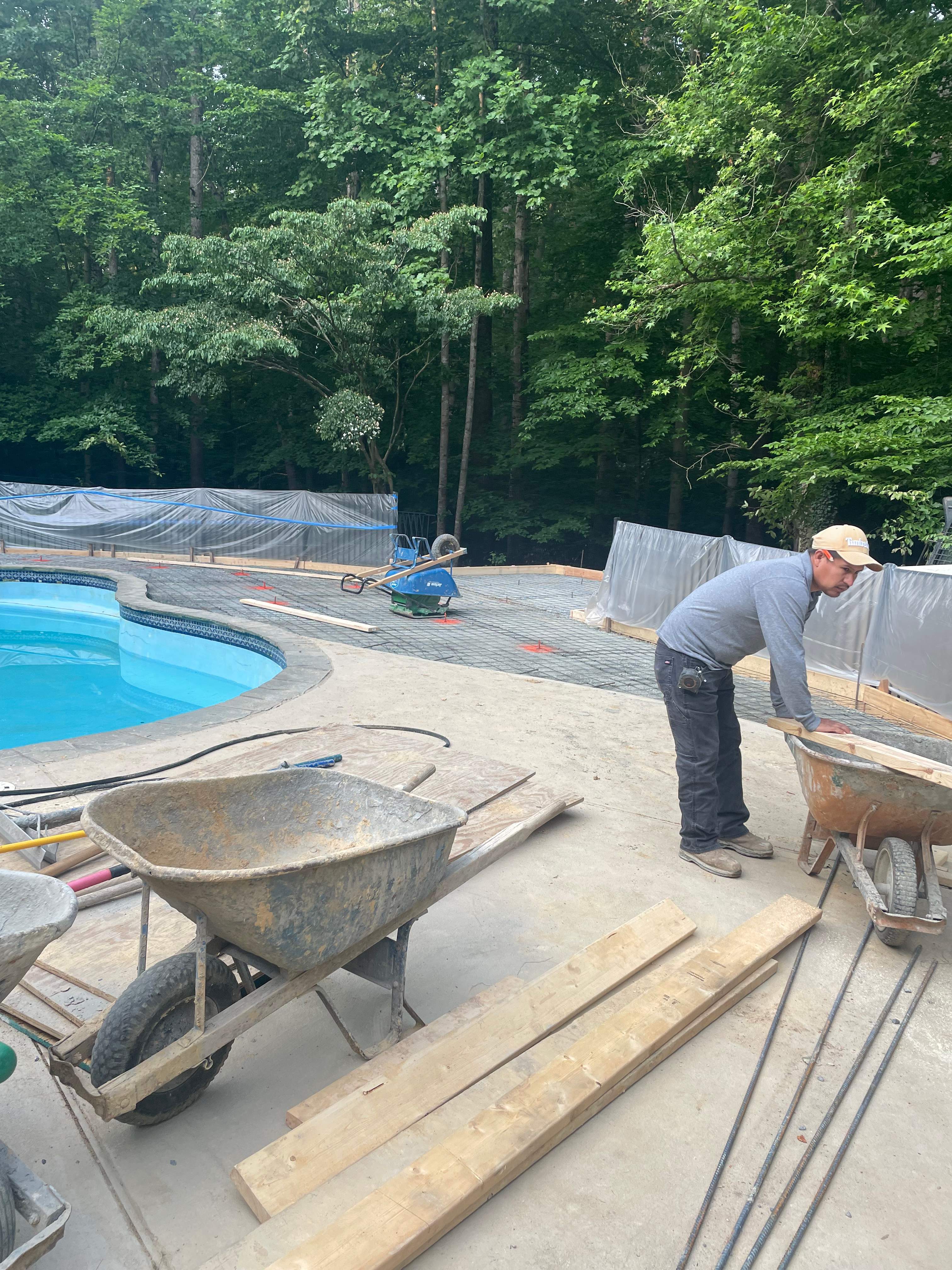 Pool Surround remodel with retaining walls, new waterfall and water slide by Fairfax Contractors, LLC