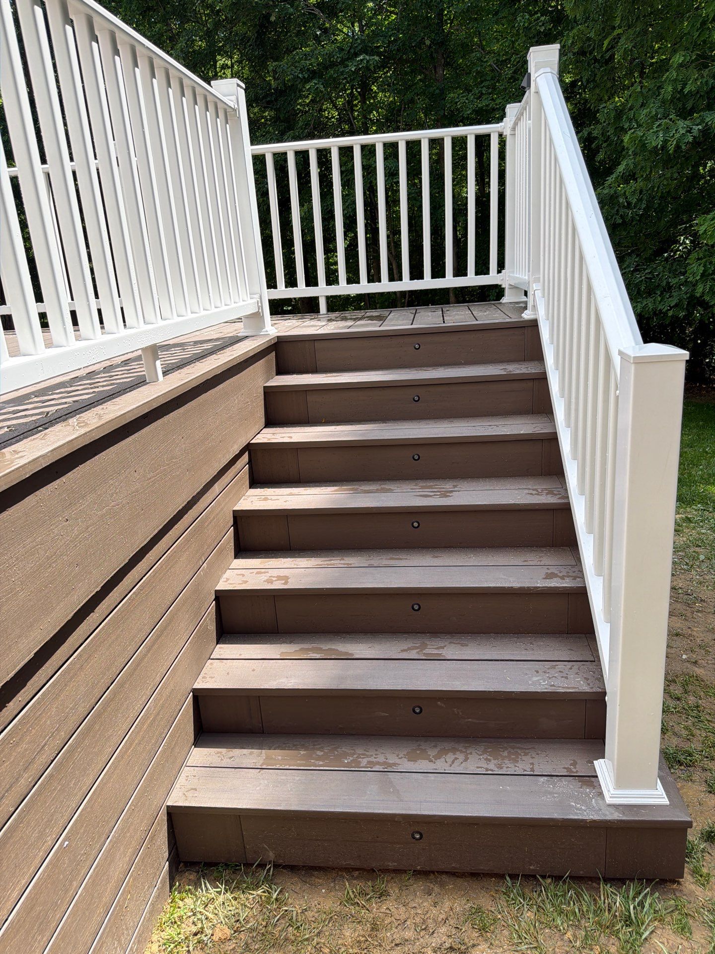 Custom Composite Deck and White Vinyl Railing Installation in Fayetteville by Walnut Hollow Decks & Outdoor Living