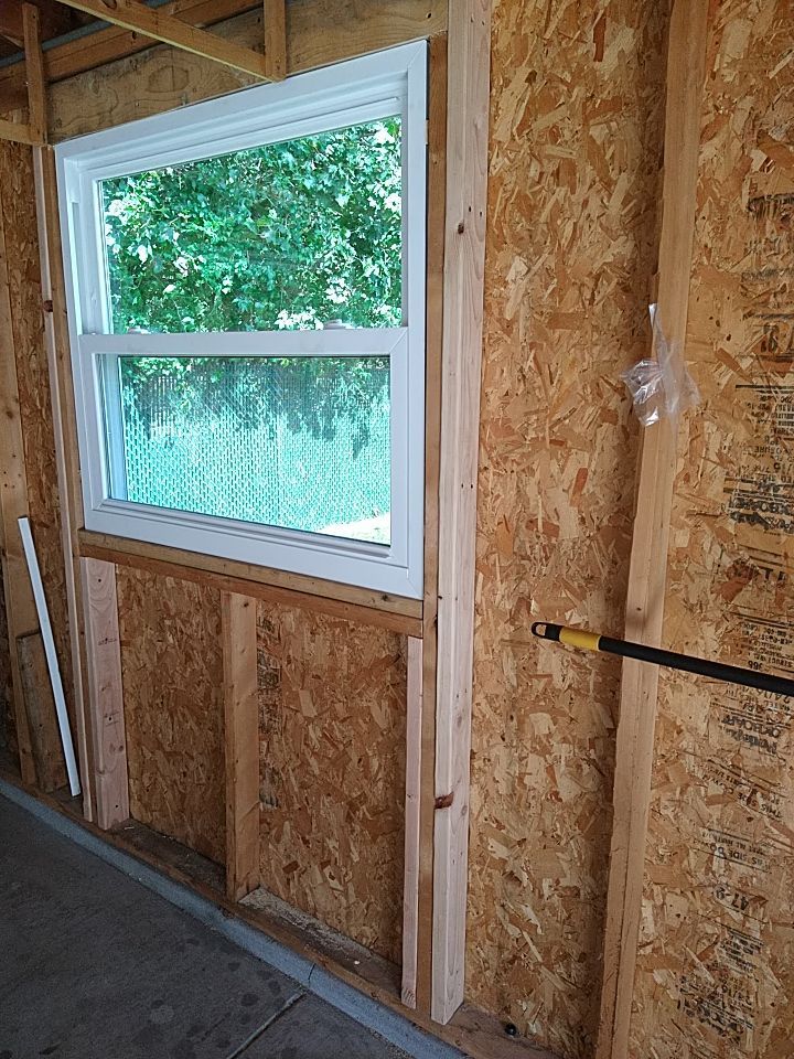Siding Installation using Norandex woodsman dl-5 white woodgrain vinyl by Absolute Roofing and Construction
