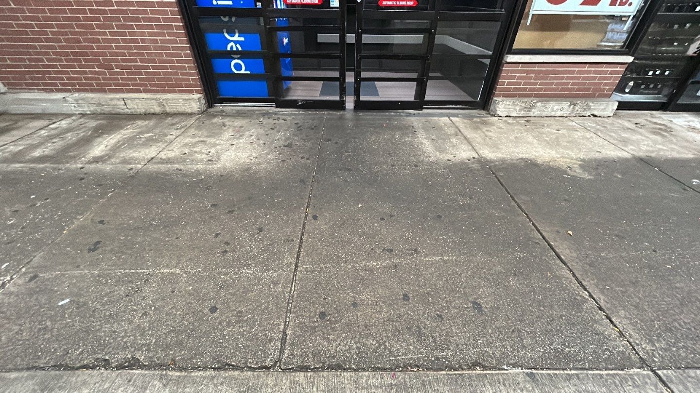 Concrete sidewalk cleaning and degreasing by Northern Power Washing LLC.