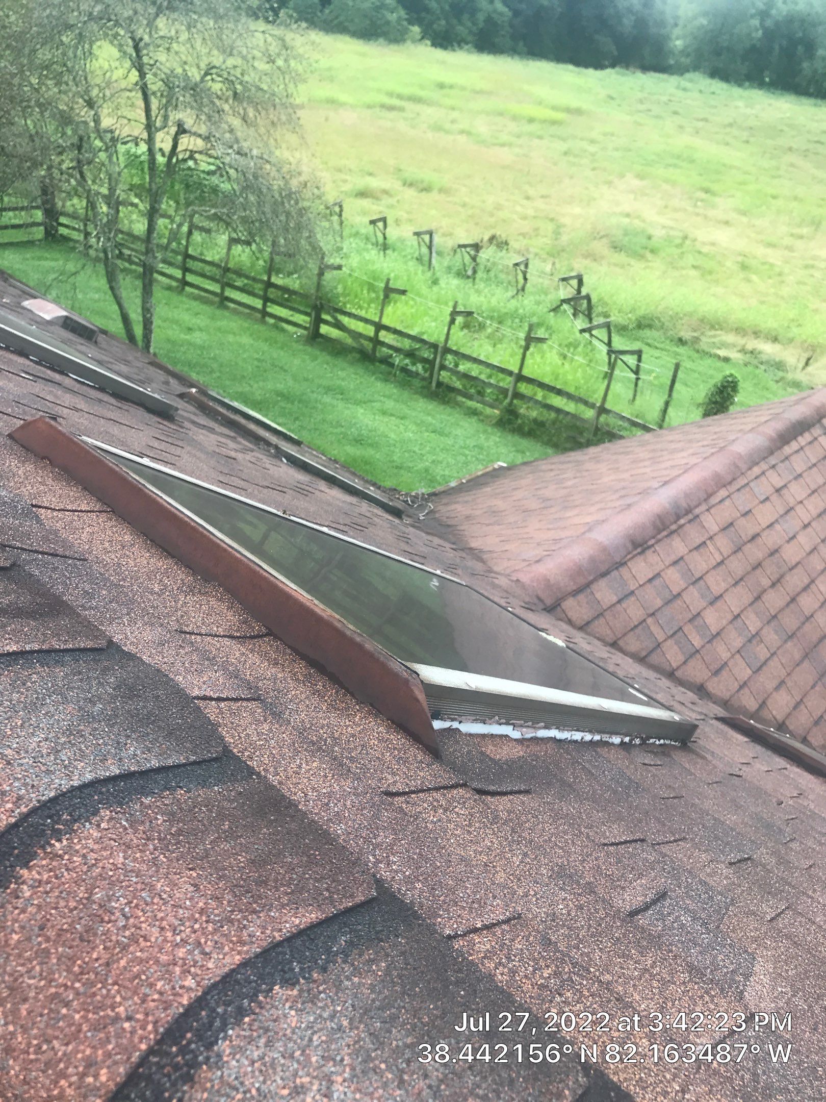 Shingle Roofing with Velux Skylight replacement and stone chimney flashing  by Secure Construction Company Inc