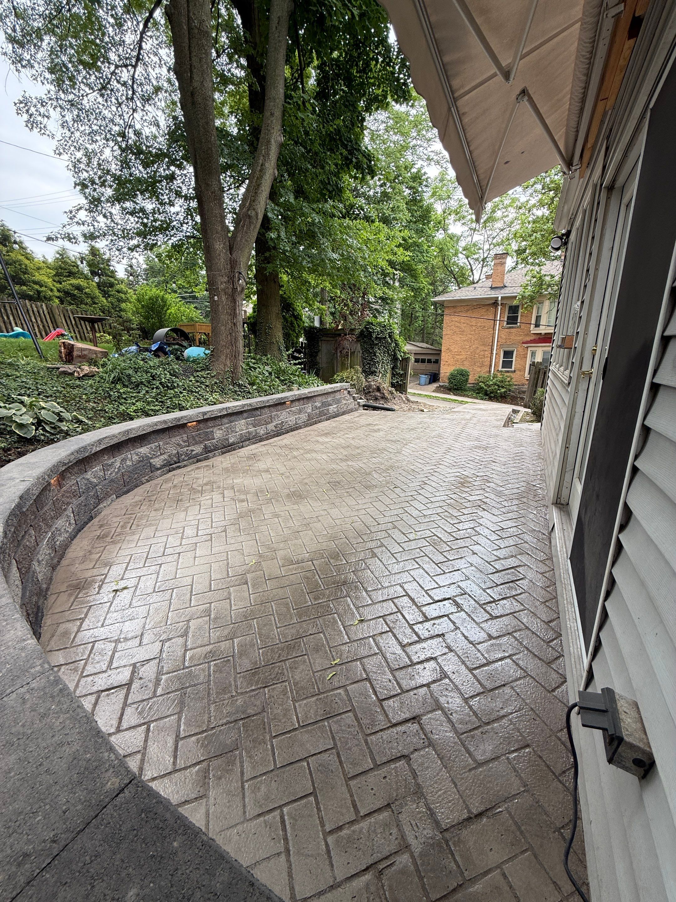 Stamped Concrete and Retaining Wall by Cousins Roofing Siding & Decks
