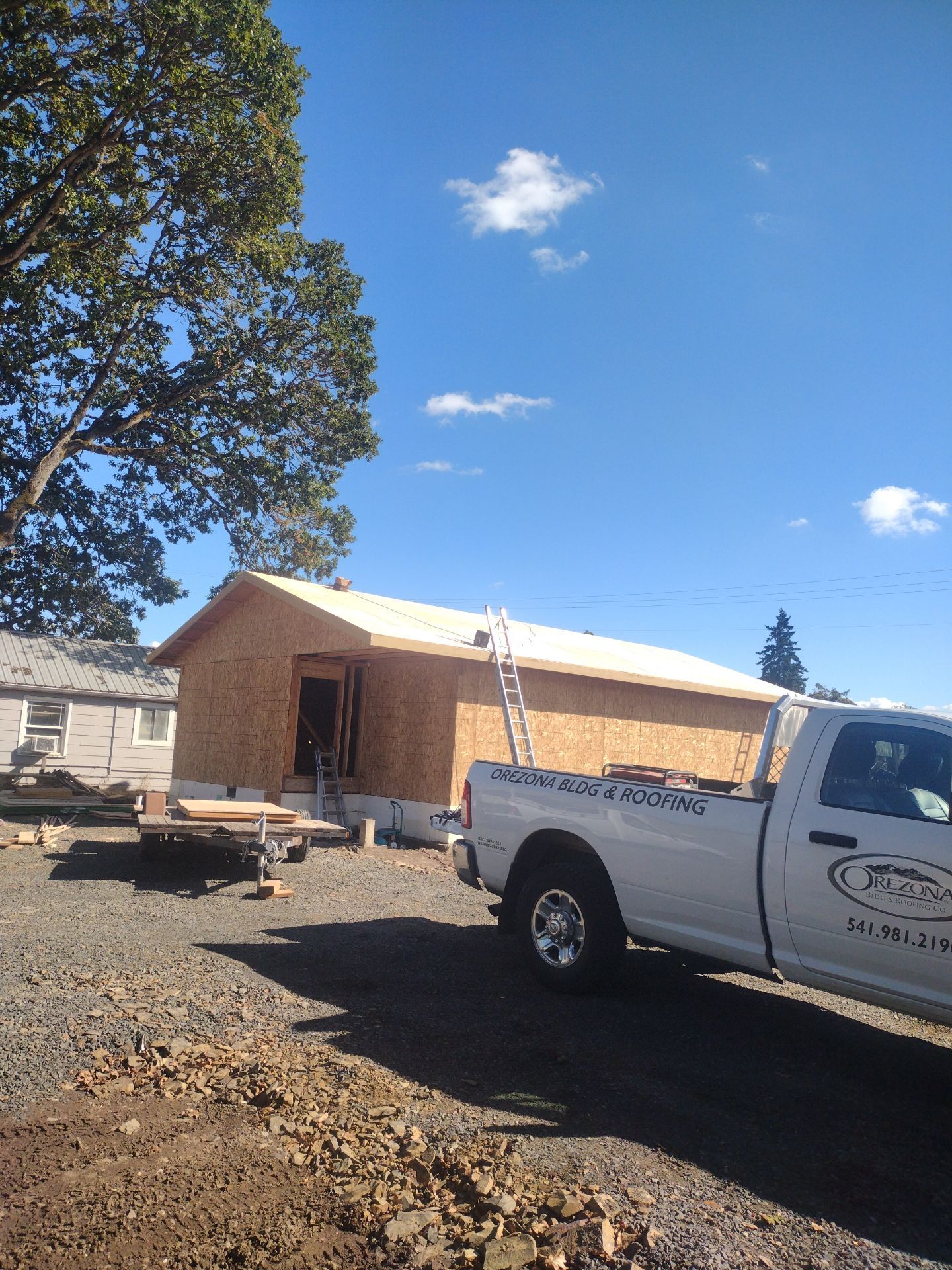 Grey Habitat for Humanity Metal Roof by Orezona Building & Roofing Company, Inc.