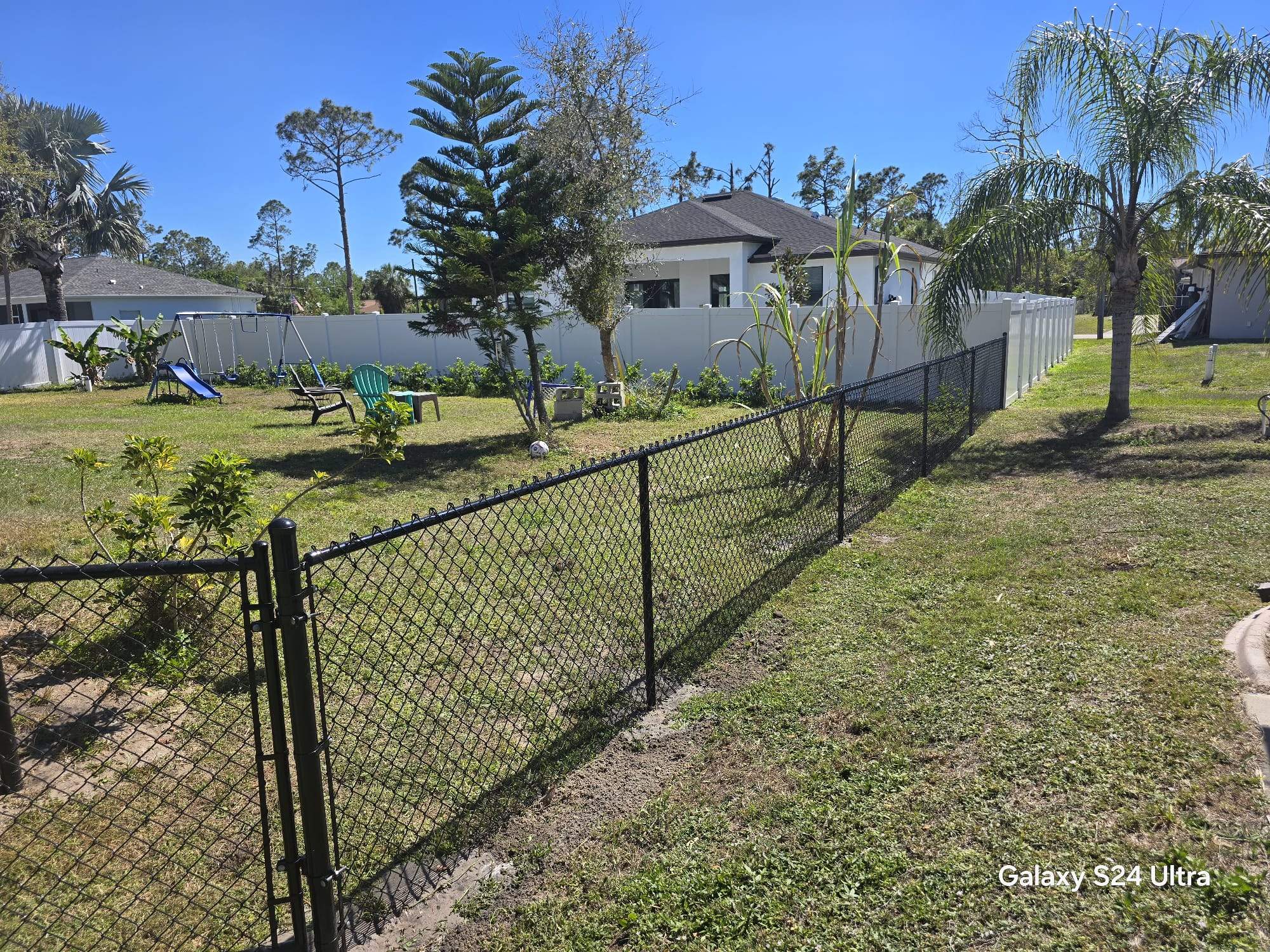 Residential Black Vinyl-Coated Chain Link Fence Installation in North Port by True Fence LLC