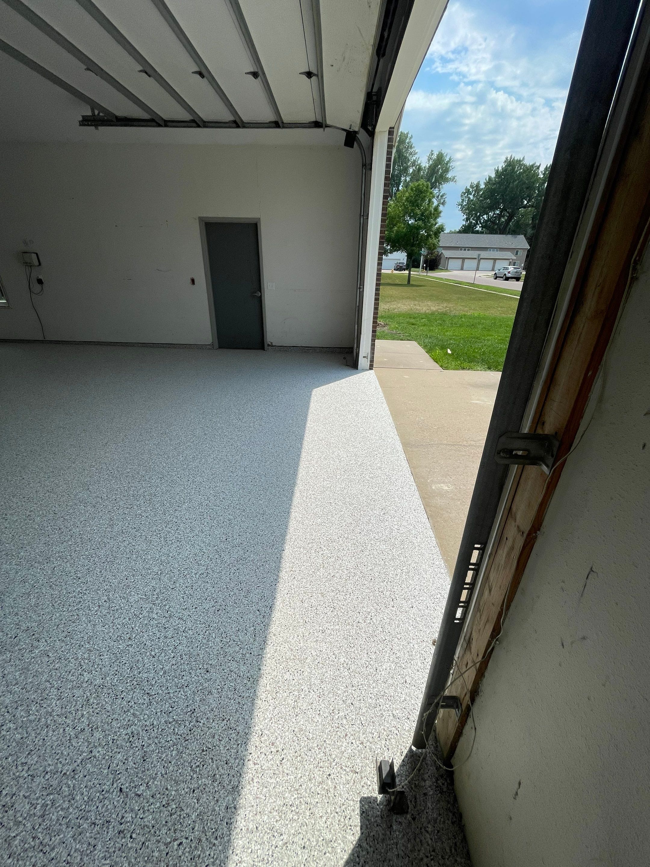 Coyote Flake Concrete Coating for Sioux Falls Garage by Select Painting, Coatings & Garage Cabinets