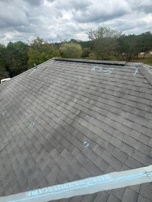 Aerial view of asphalt shingle roof with inspection markings