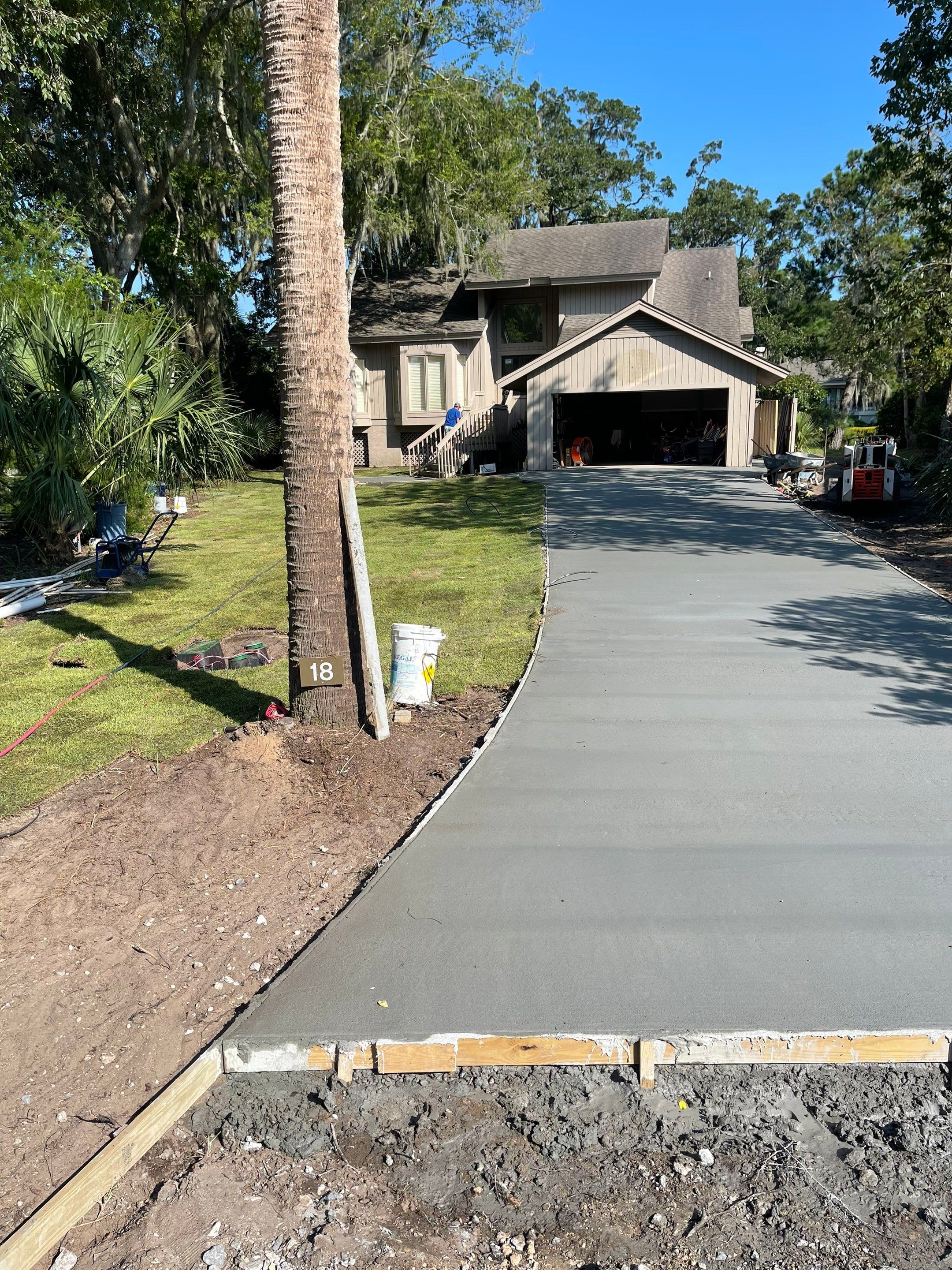 Concrete Driveway Replacement with Brick Paver Accents in Hilton Head Island by Lowcountry Scapes, LLC