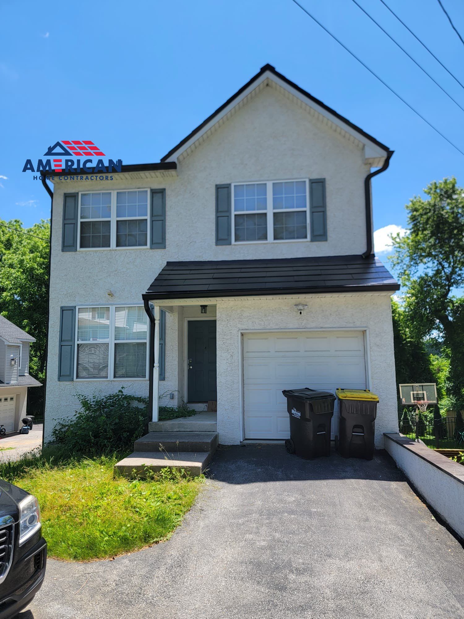 Tesla Solar Roof, Powerwall, and Black Gutters by American Home Contractors