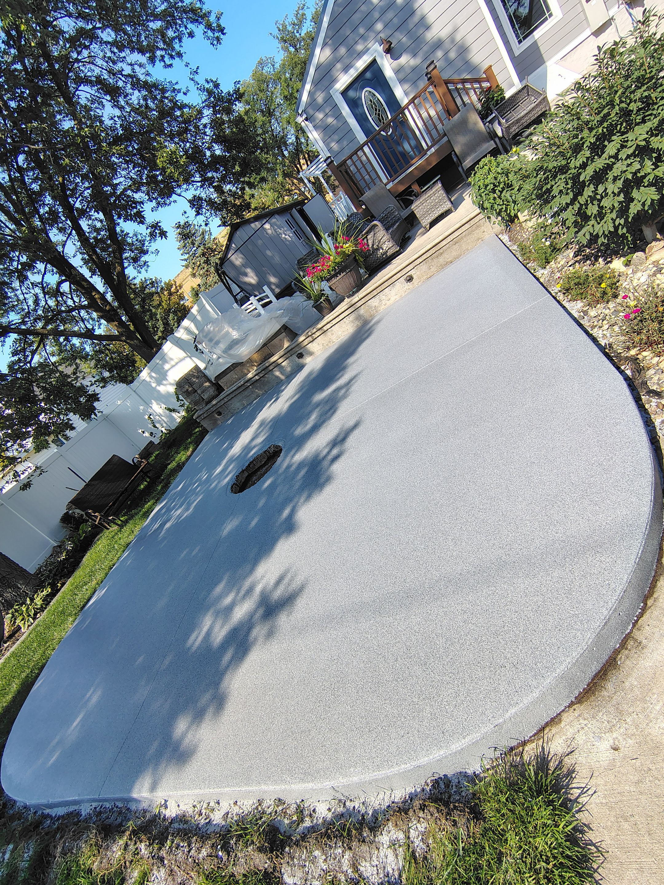 Custom Garage Floor Coating and Backyard Patio Refinishing in Tyndall by Select Painting, Coatings & Garage Cabinets