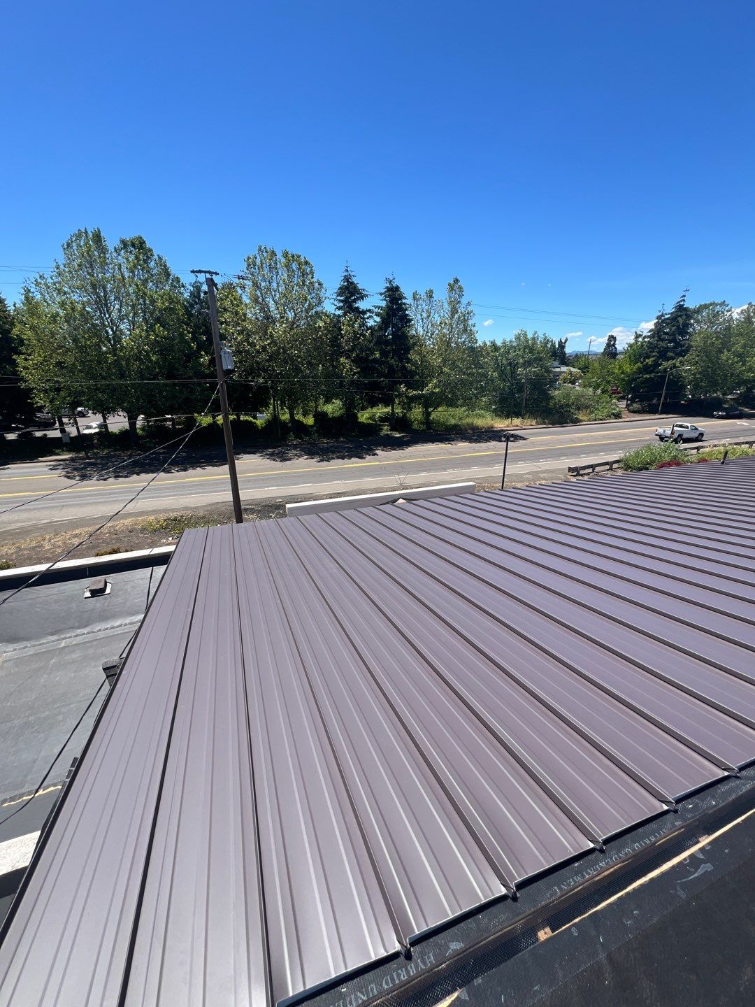 Commercial Flat Roof Installation using Bruce and Dana Snap Lock Metal (Color: Brown) by Orezona Building & Roofing Company, Inc.